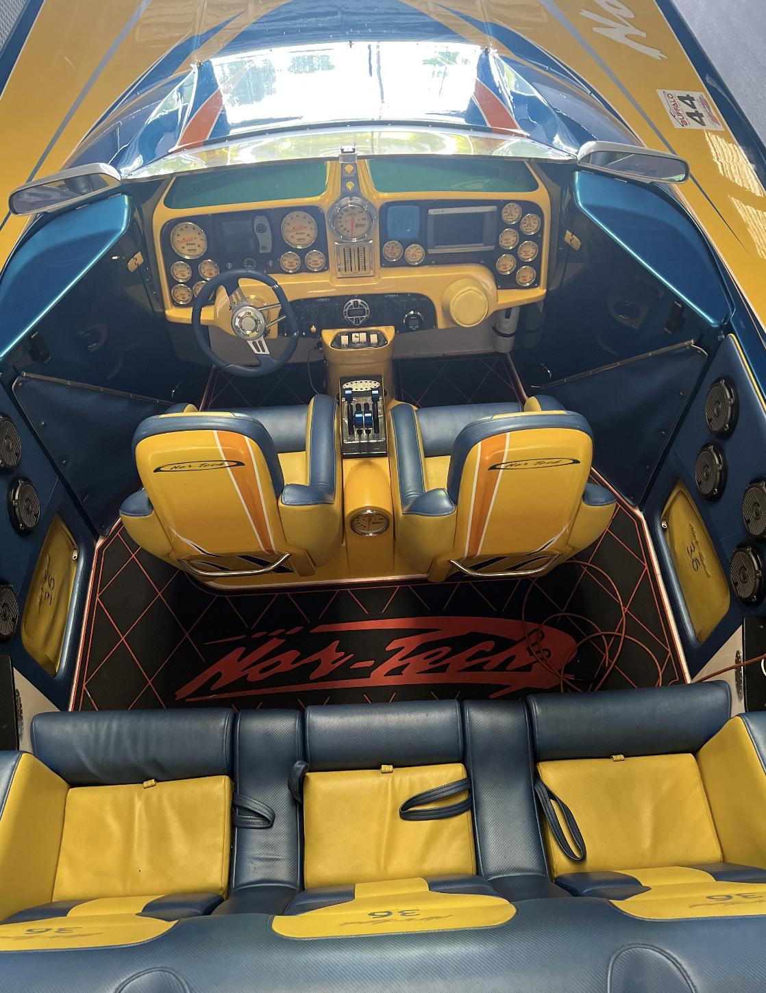 2007 Nor-Tech 3600 Supercat boat interior with yellow and black seats and dashboard.