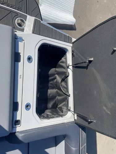 2025 Moomba Mondo boat storage compartment with open lid and black interior.