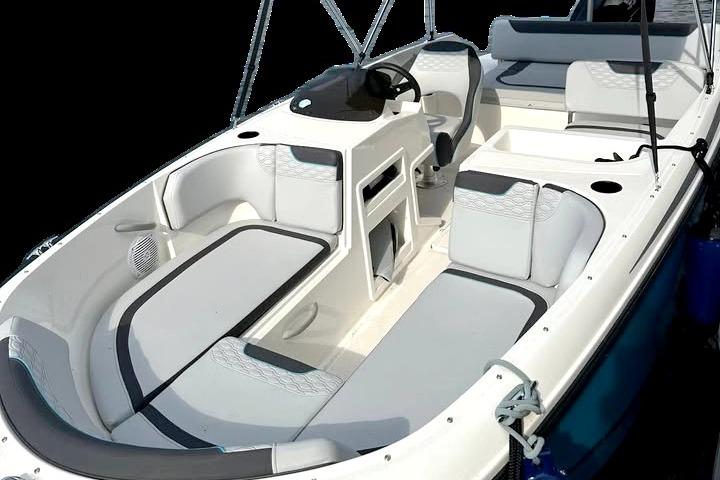 2024 Bayliner Element M19 boat interior with modern seating and steering console.