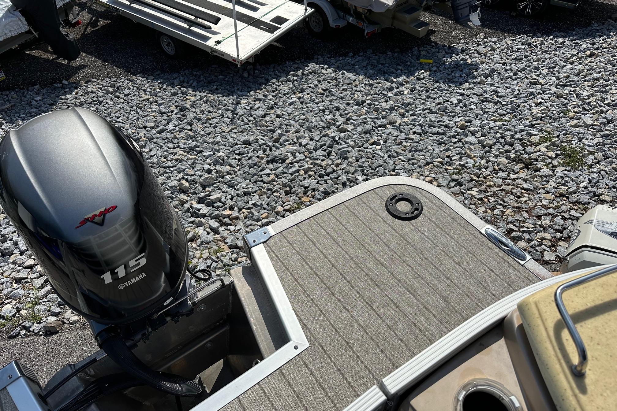 2017 Bennington 22 GPD boat with Yamaha 115 engine on gravel surface.