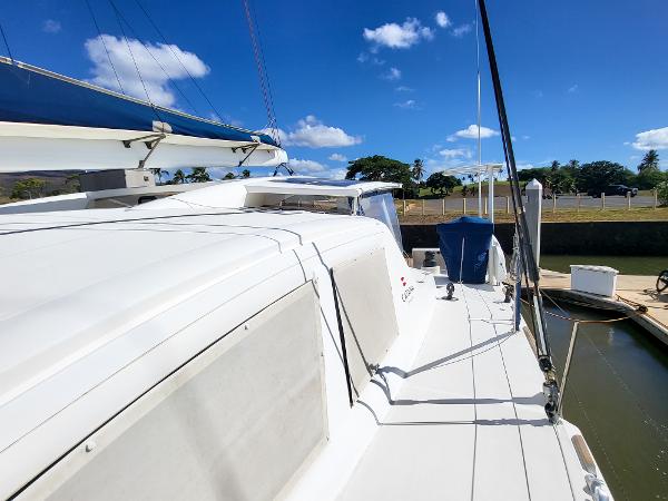 2009 Catana 65 catamaran docked under clear blue sky.