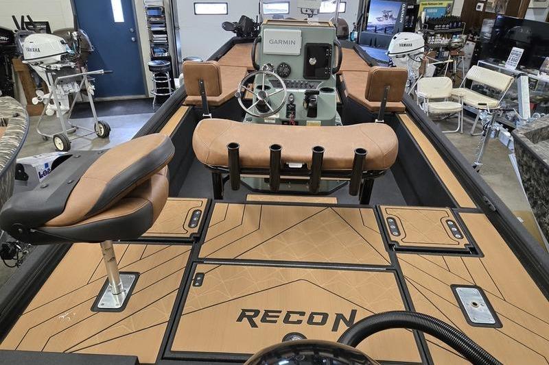 2026 Avid 207 Recon boat interior with tan seating and Garmin navigation system.