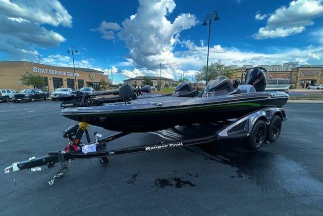 2026 Ranger Z518 Cup-Equipped boat on trailer in parking lot, under cloudy sky.