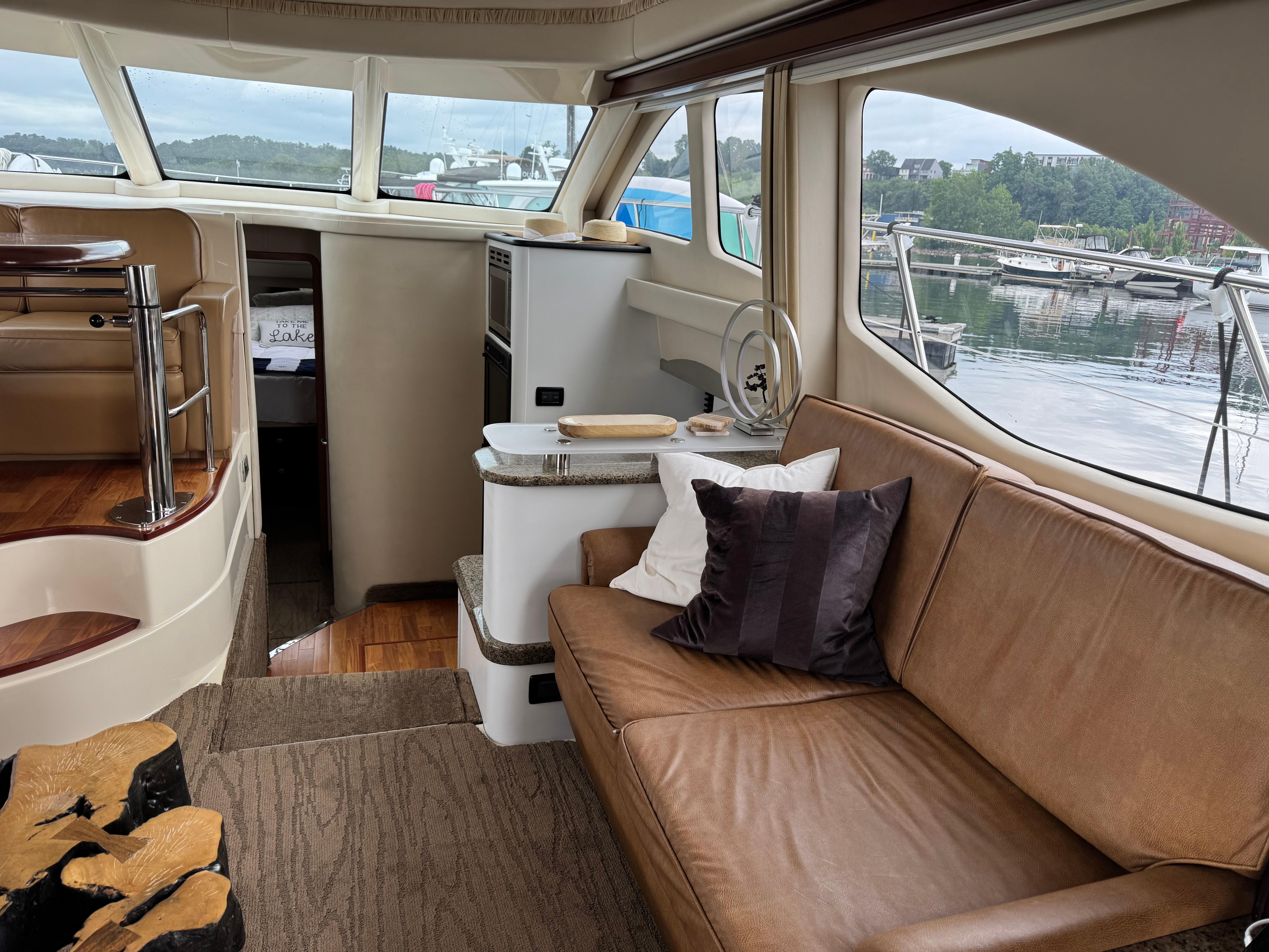 Luxurious interior of 2005 Sea Ray 420 Sedan Bridge yacht with comfortable seating and scenic views.