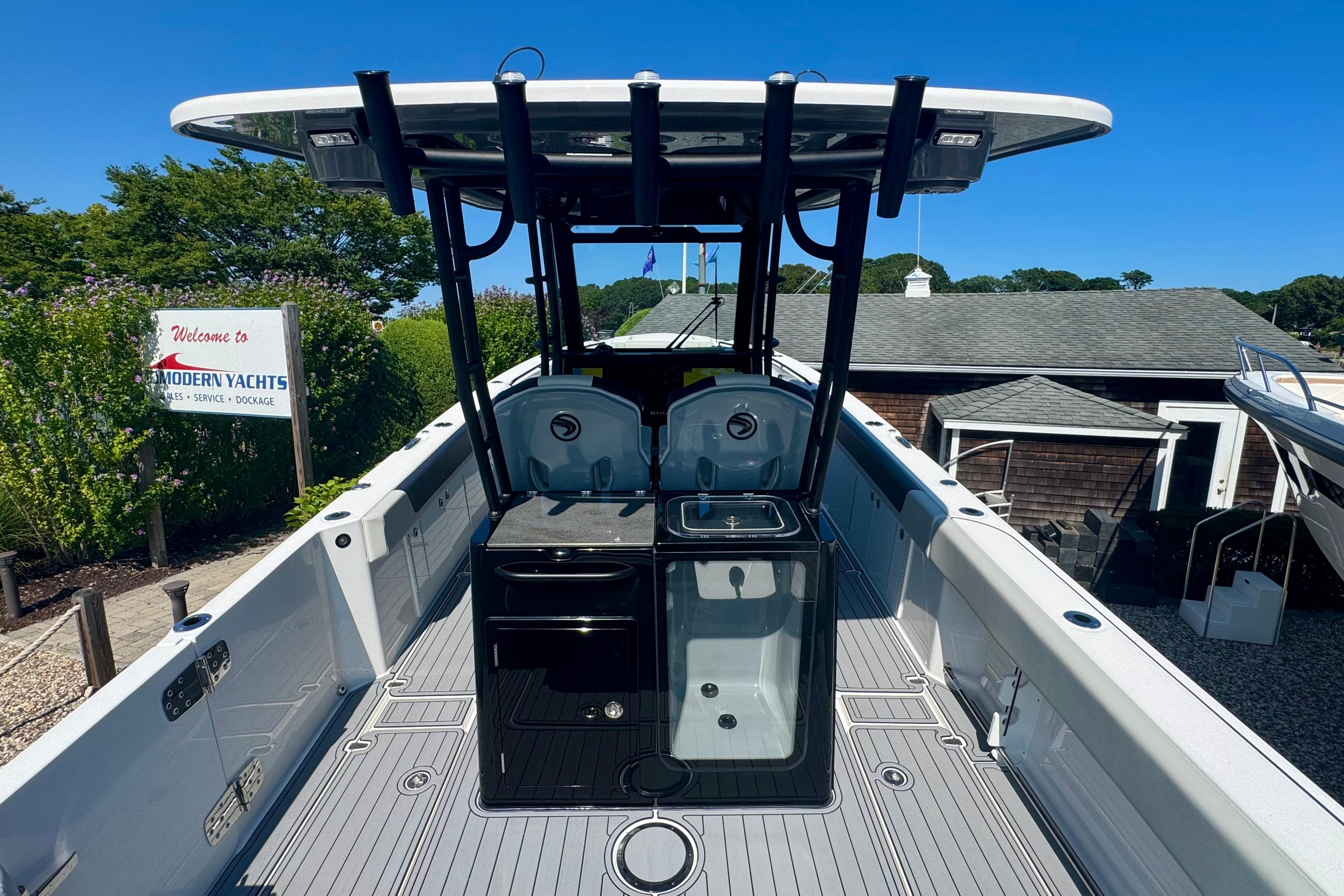 Edgewater 340CC 2025 boat at Modern Yachts dealership under clear blue sky.