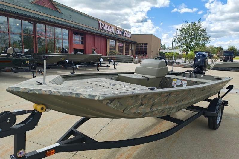 2025 Tracker Grizzly 1648 SC boat displayed at Tracker Boat Center under a blue sky.