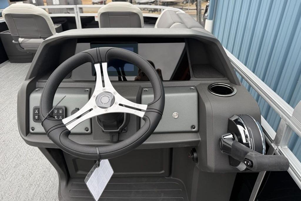 2026 Sun Tracker Fishin' Barge 20 DLX steering console with modern controls and cup holder.