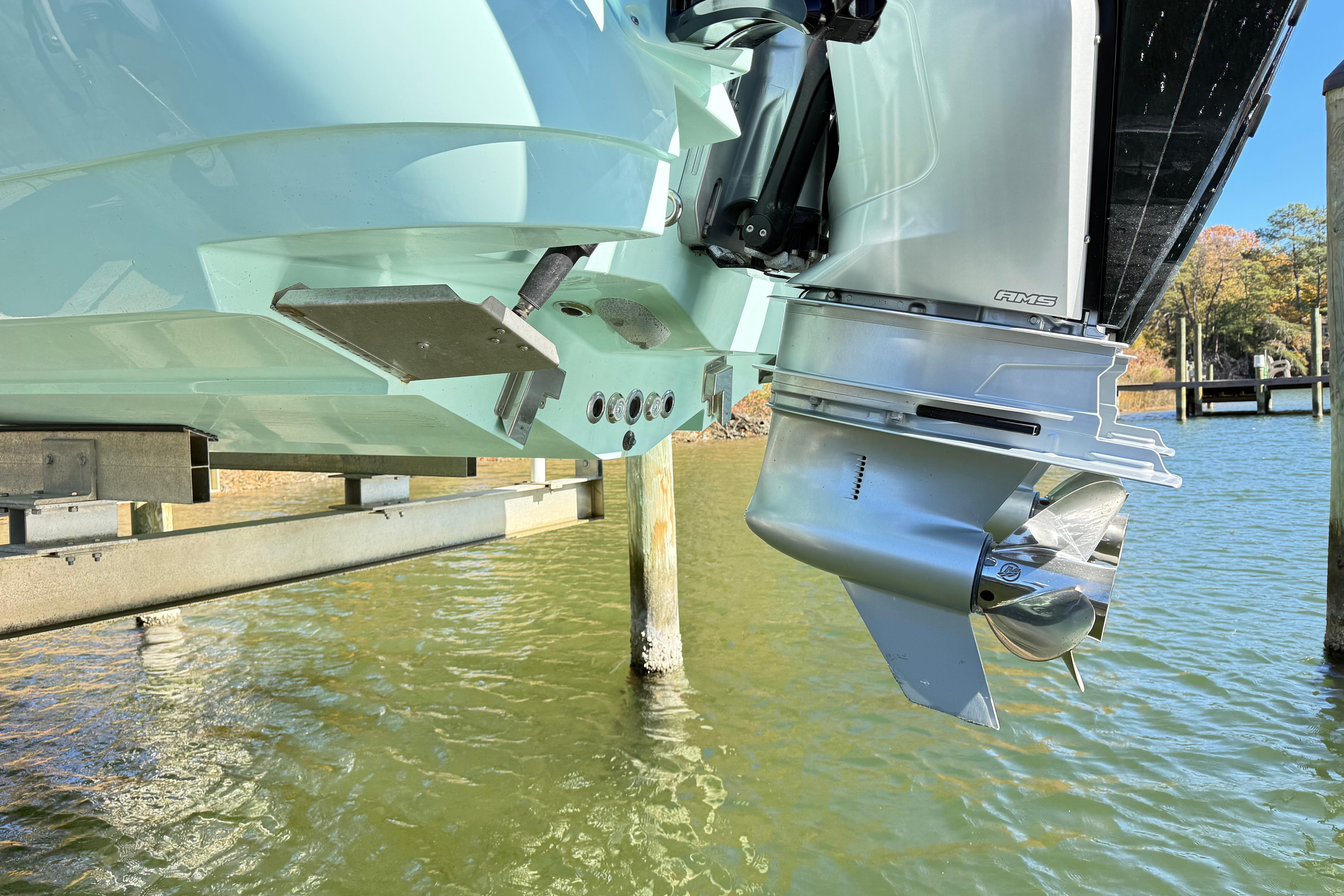 2023 Caymas 281 HB boat engine and propeller above water.