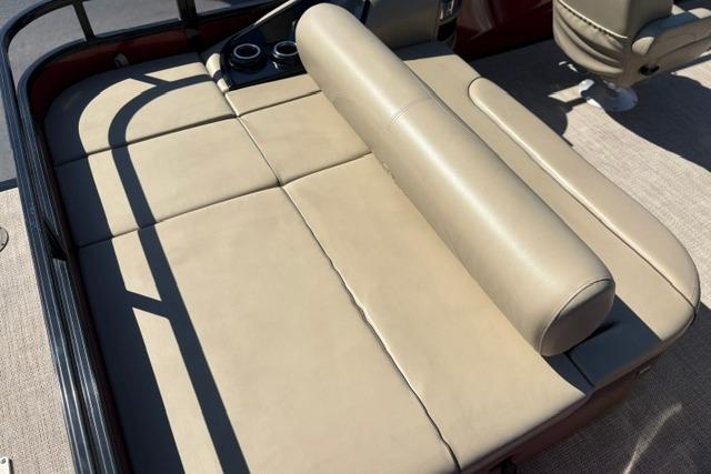 Luxurious seating on 2025 Regency 250 DL3 pontoon boat, featuring beige upholstery and cup holders.