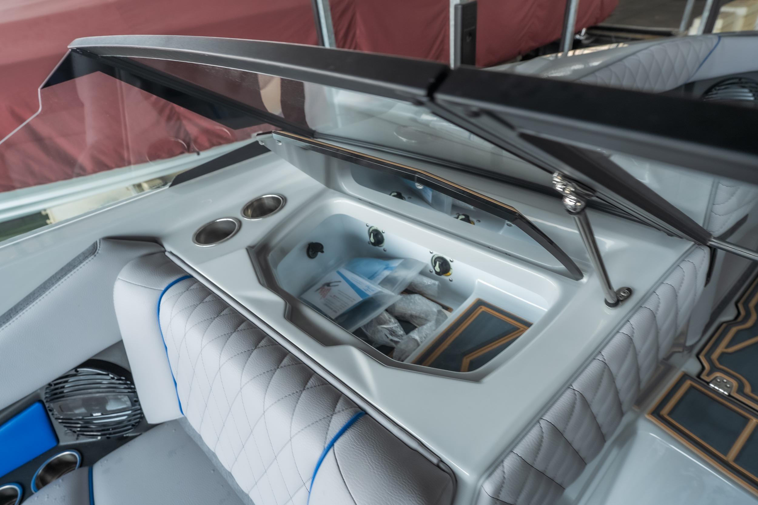 2026 Tigé Z3 boat interior with open storage compartment and cup holders.