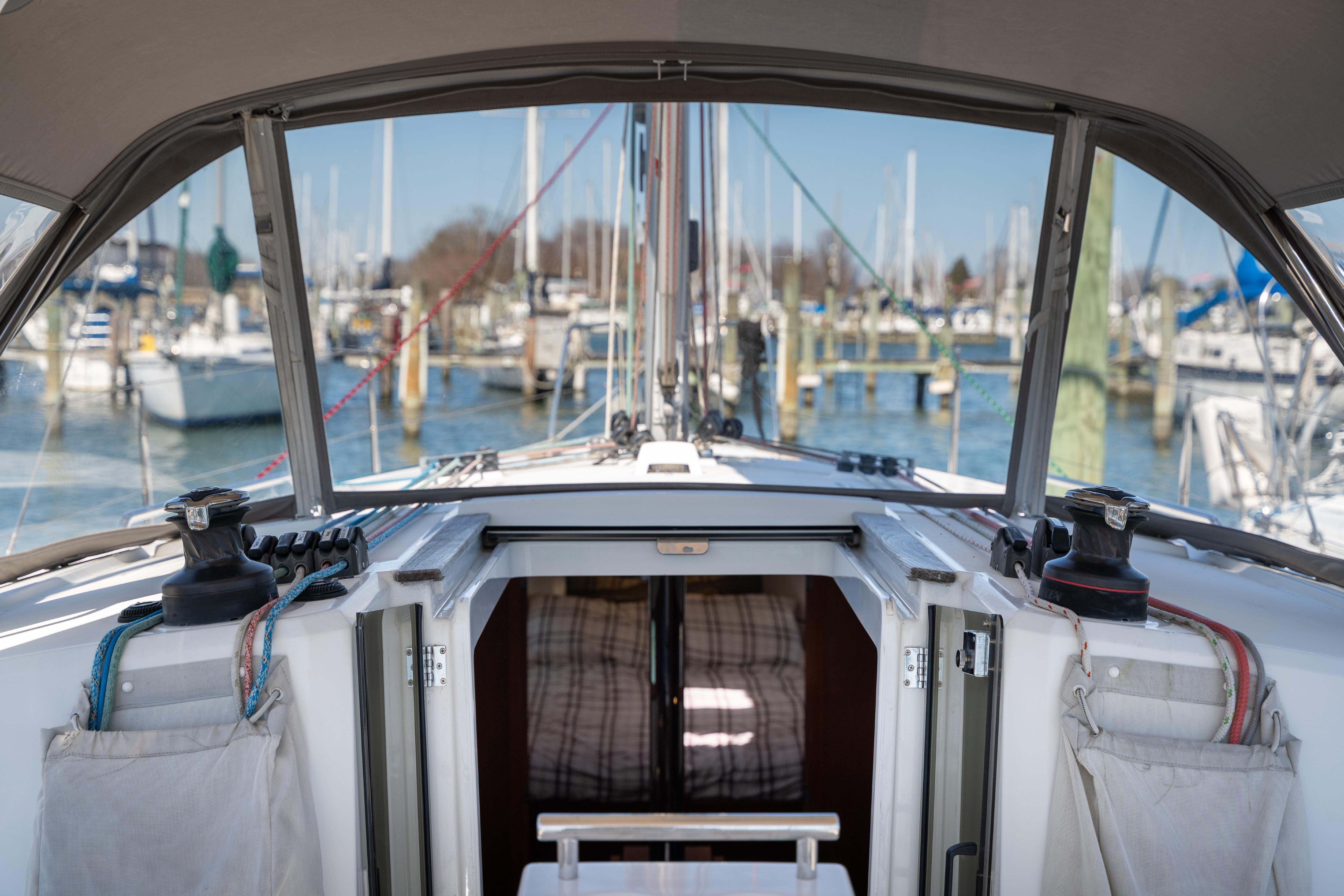 2018 Beneteau Oceanis 38.1 sailboat cockpit view in marina setting.