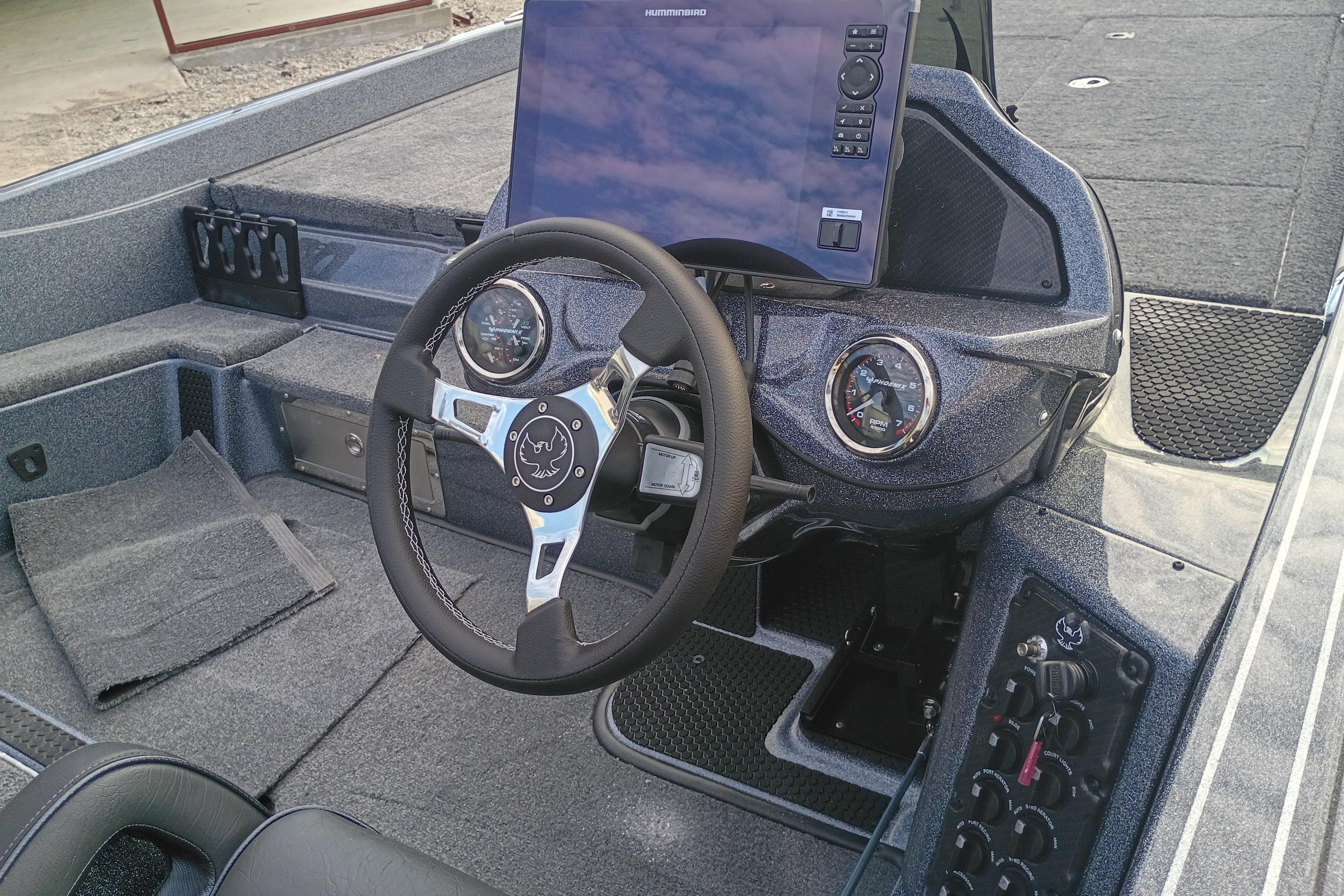 Interior of 2026 Phoenix 921 ELITEX boat with steering wheel and dashboard controls.