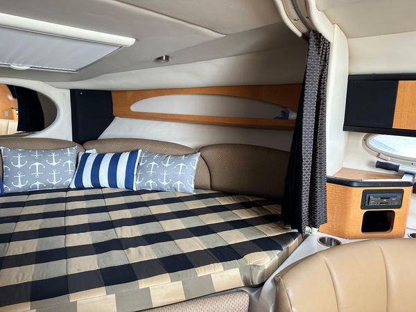 Interior of 2006 Chaparral Signature 310 yacht with cozy bed.