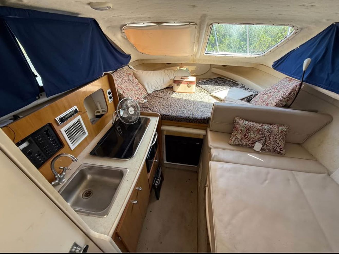 Interior of 2003 Bayliner 2452 Classic Cruiser with kitchen and sleeping area.