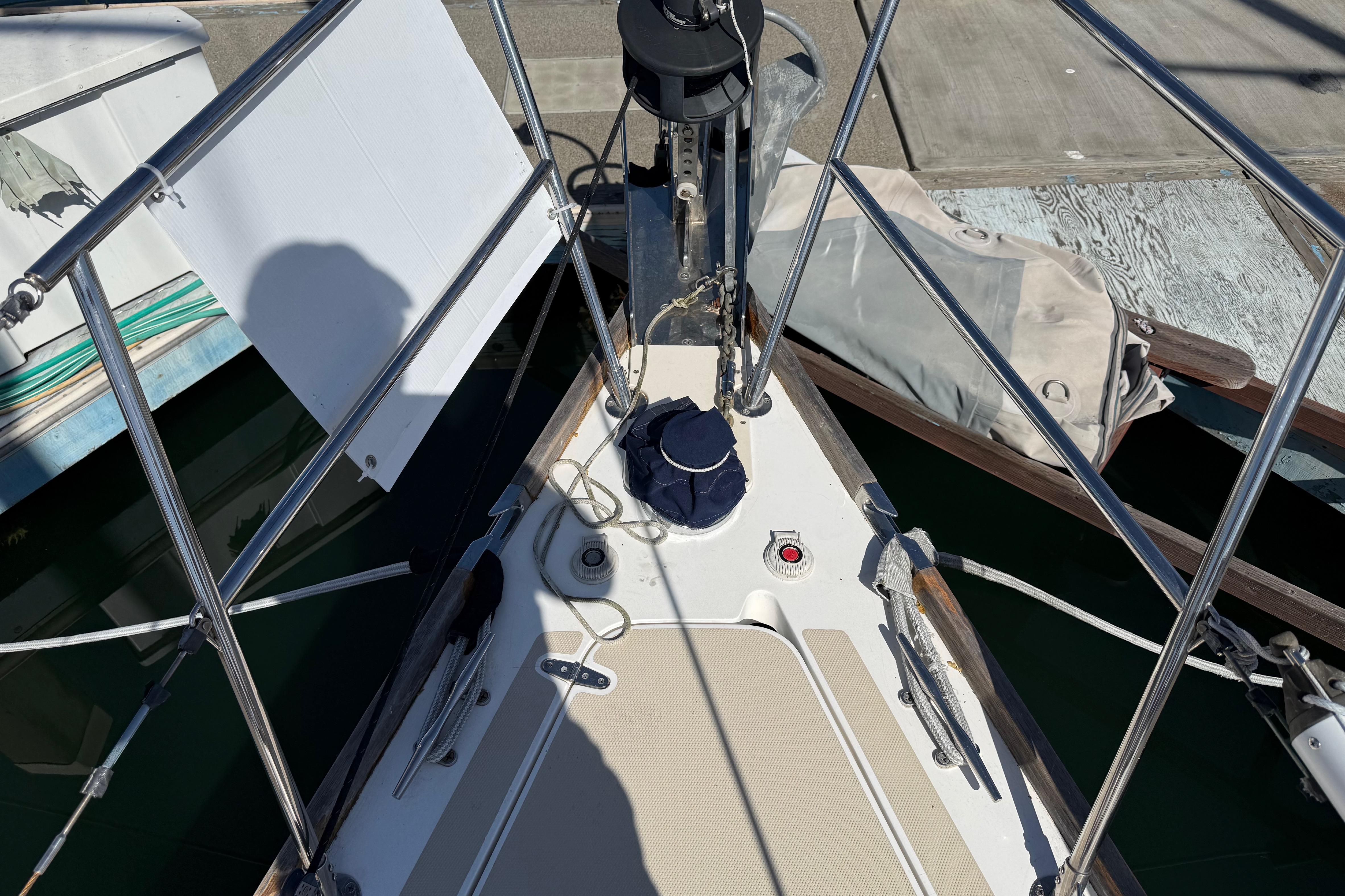 Bow of a 2004 Sabre 386 sailboat docked, featuring deck equipment and railing.