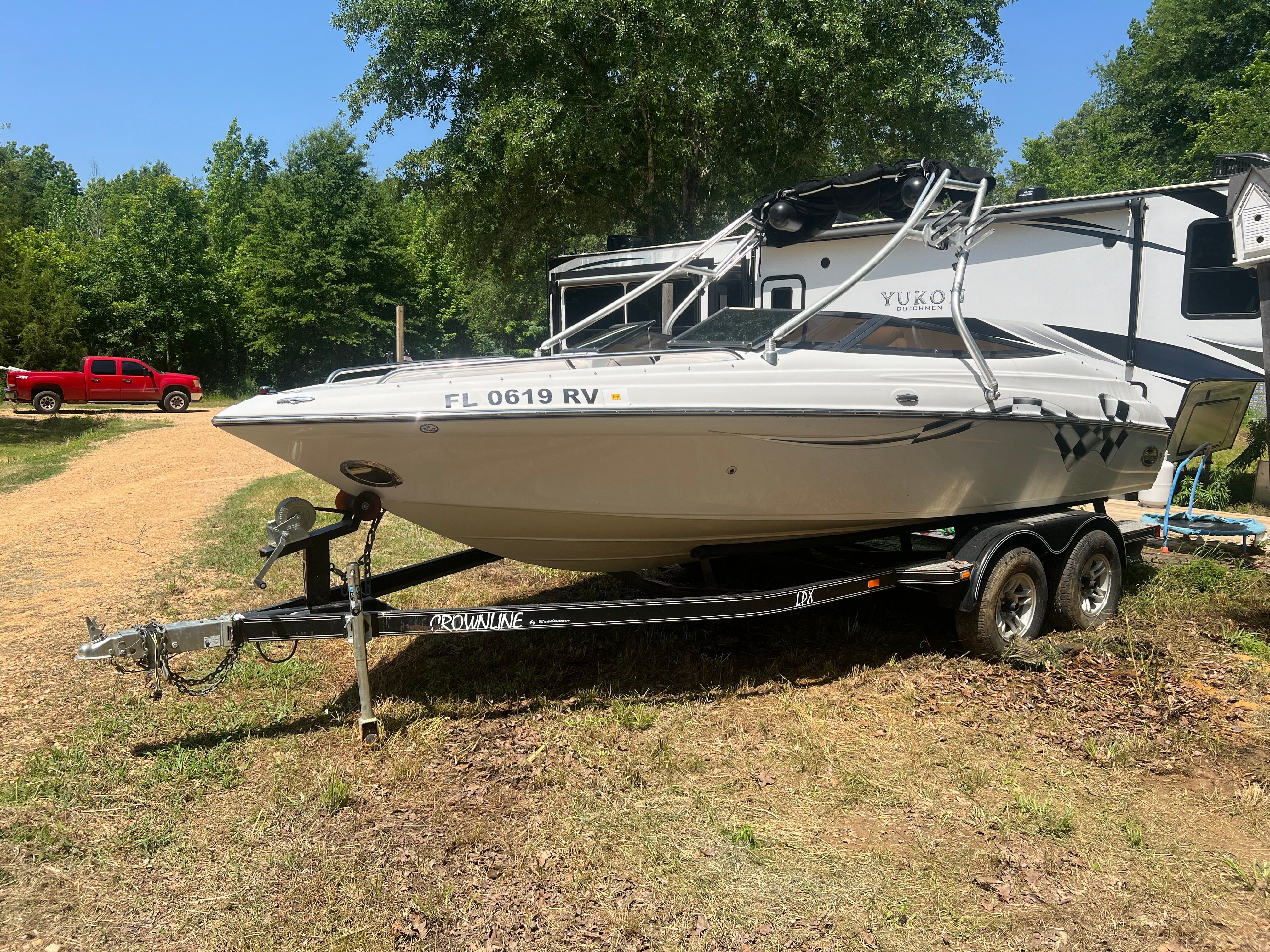 2001 Crownline 202 BR boat parked on trailer outdoors.