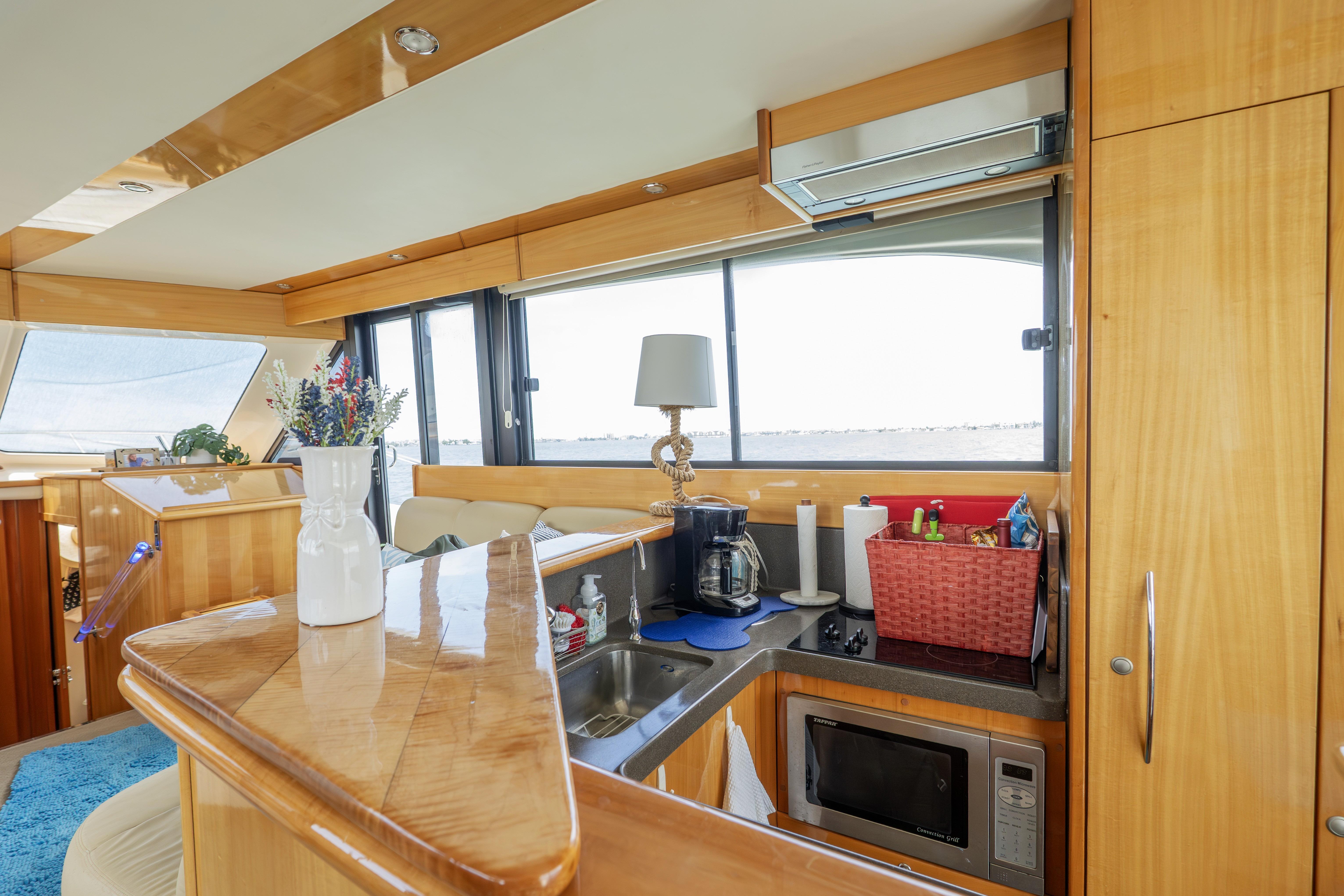 Luxurious interior of a 2008 Maritimo 52 yacht with modern kitchen amenities.