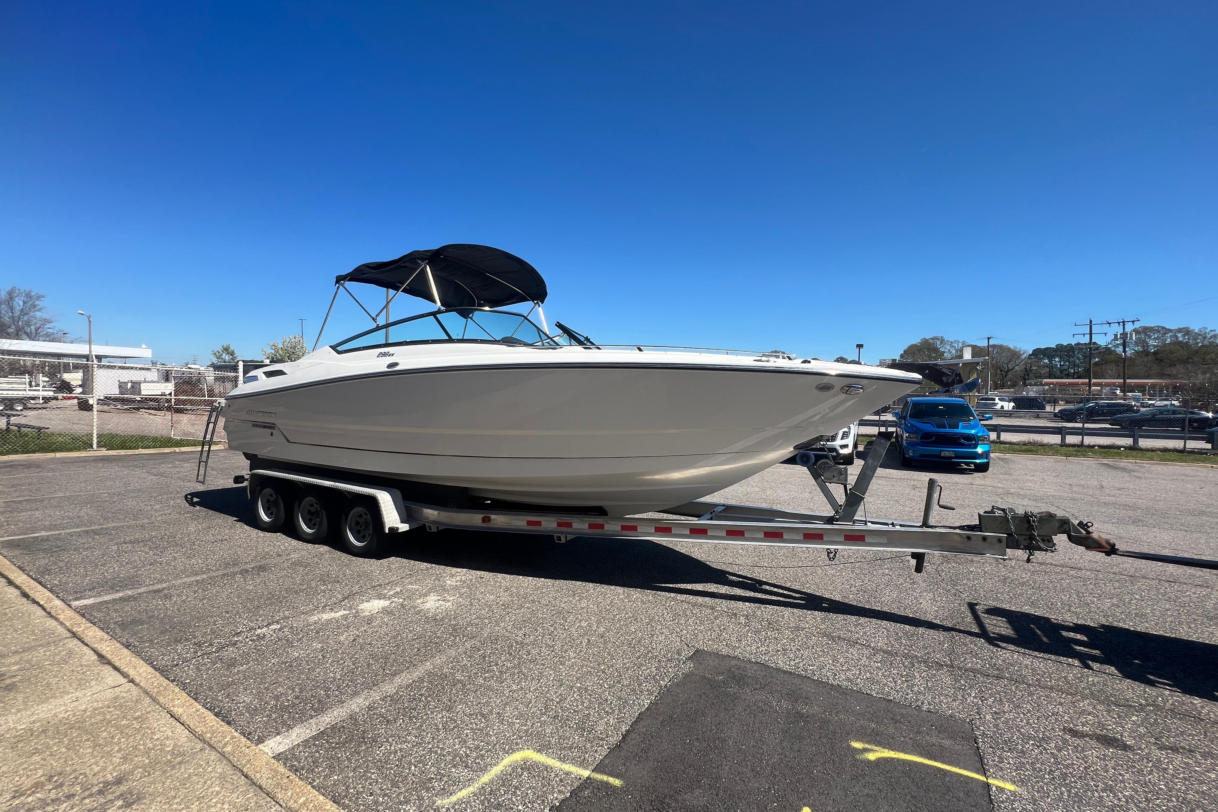 2017 Monterey 298SS Super Sport boat on trailer in parking lot under clear blue sky.