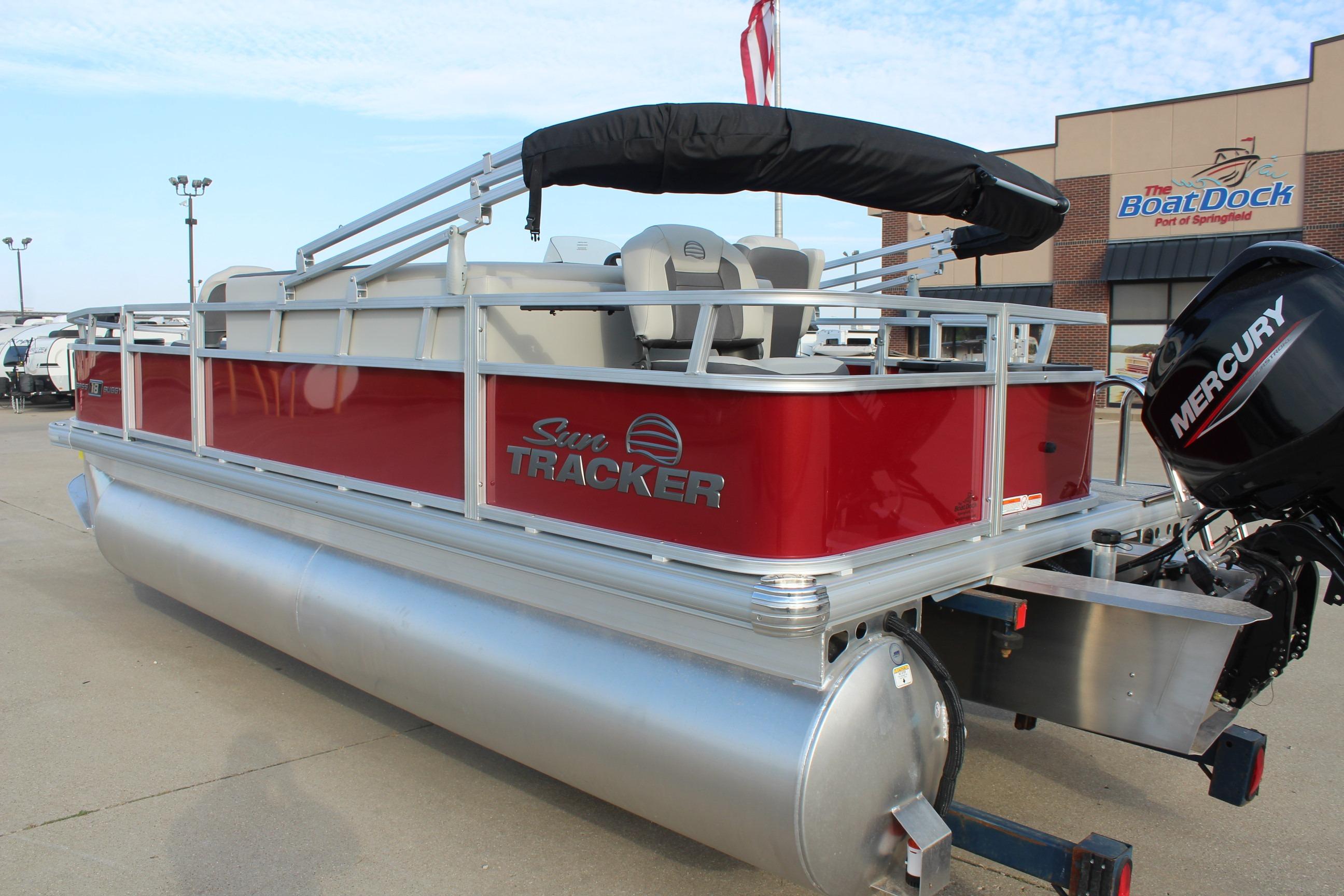2026 Sun Tracker Bass Buggy 18 DLX pontoon boat with Mercury engine at dealership.
