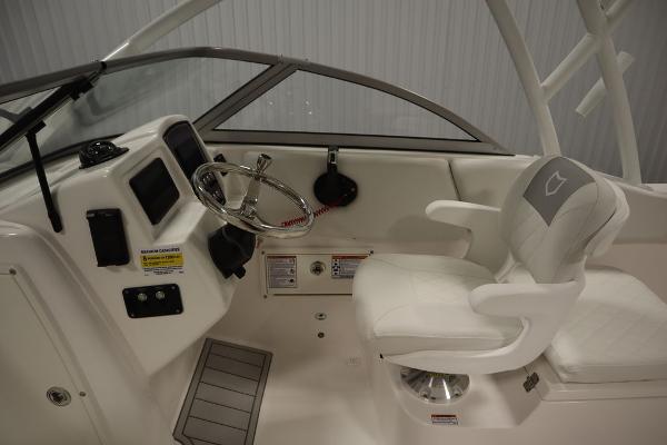 2025 Sea Fox 228 Traveler boat interior with steering wheel and captain's chair.