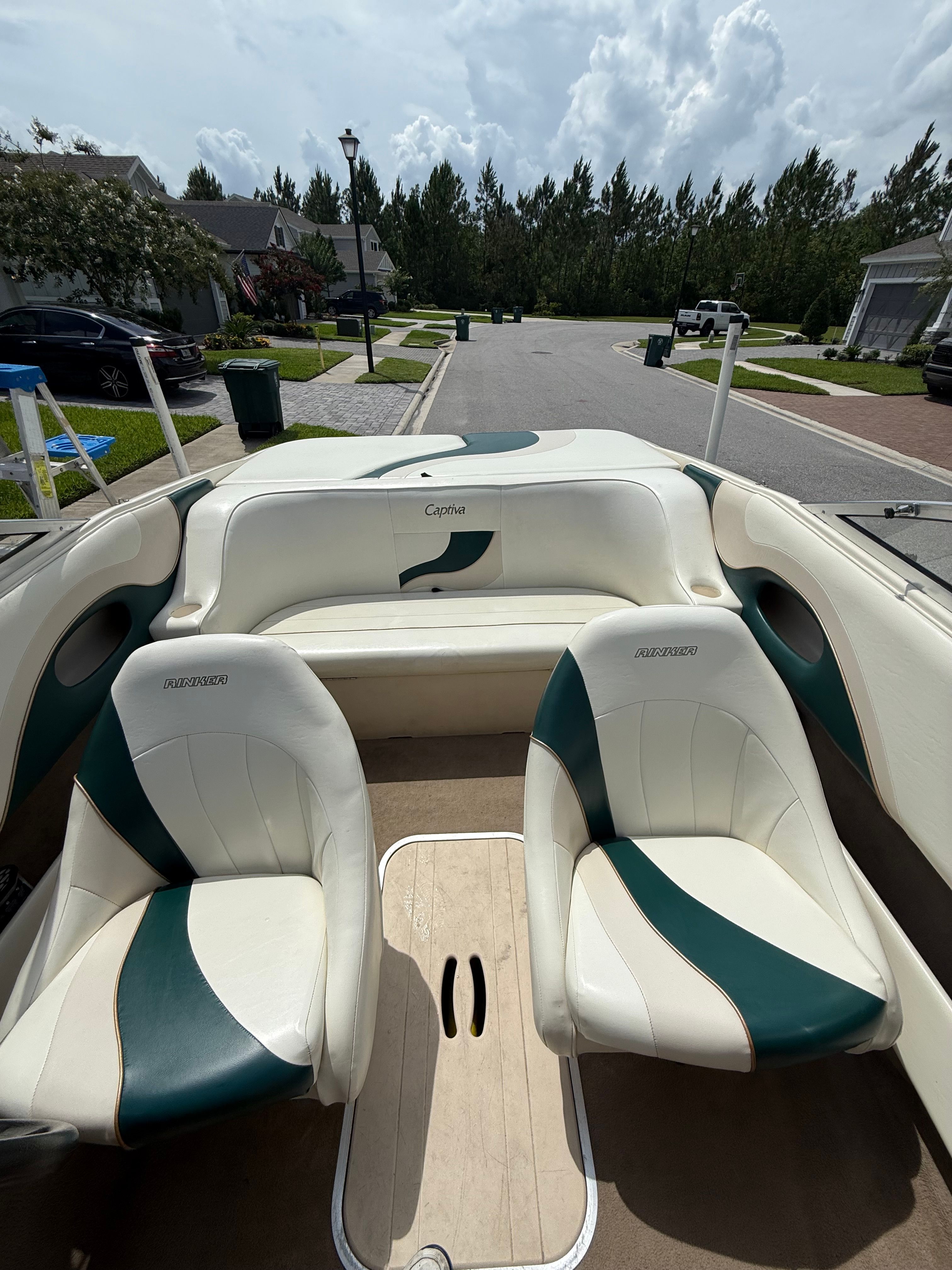 Interior view of a Rinker Captiva boat with two seats and a bench.