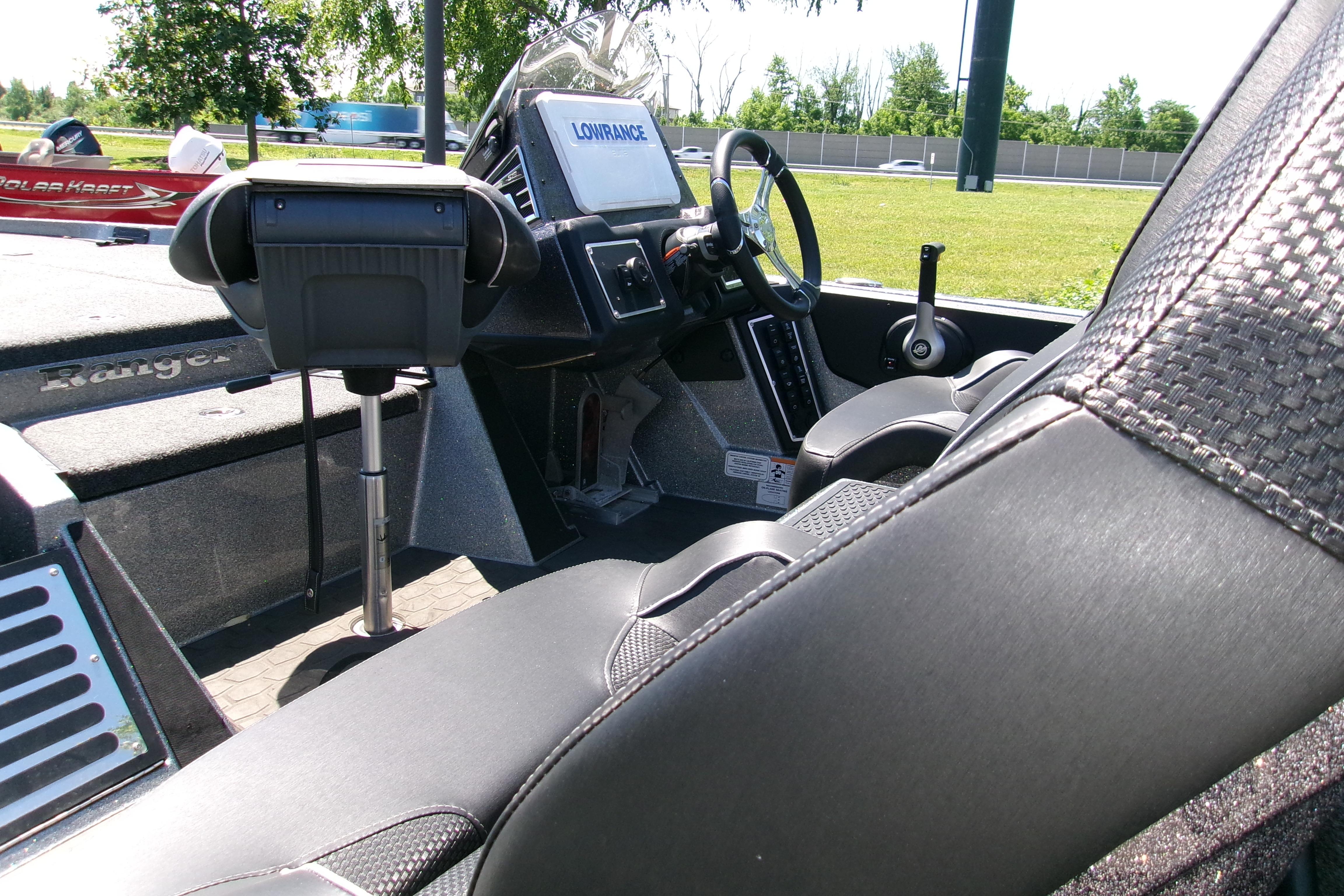 2025 Ranger Z519R Cup-Equipped boat interior with steering wheel and seating.