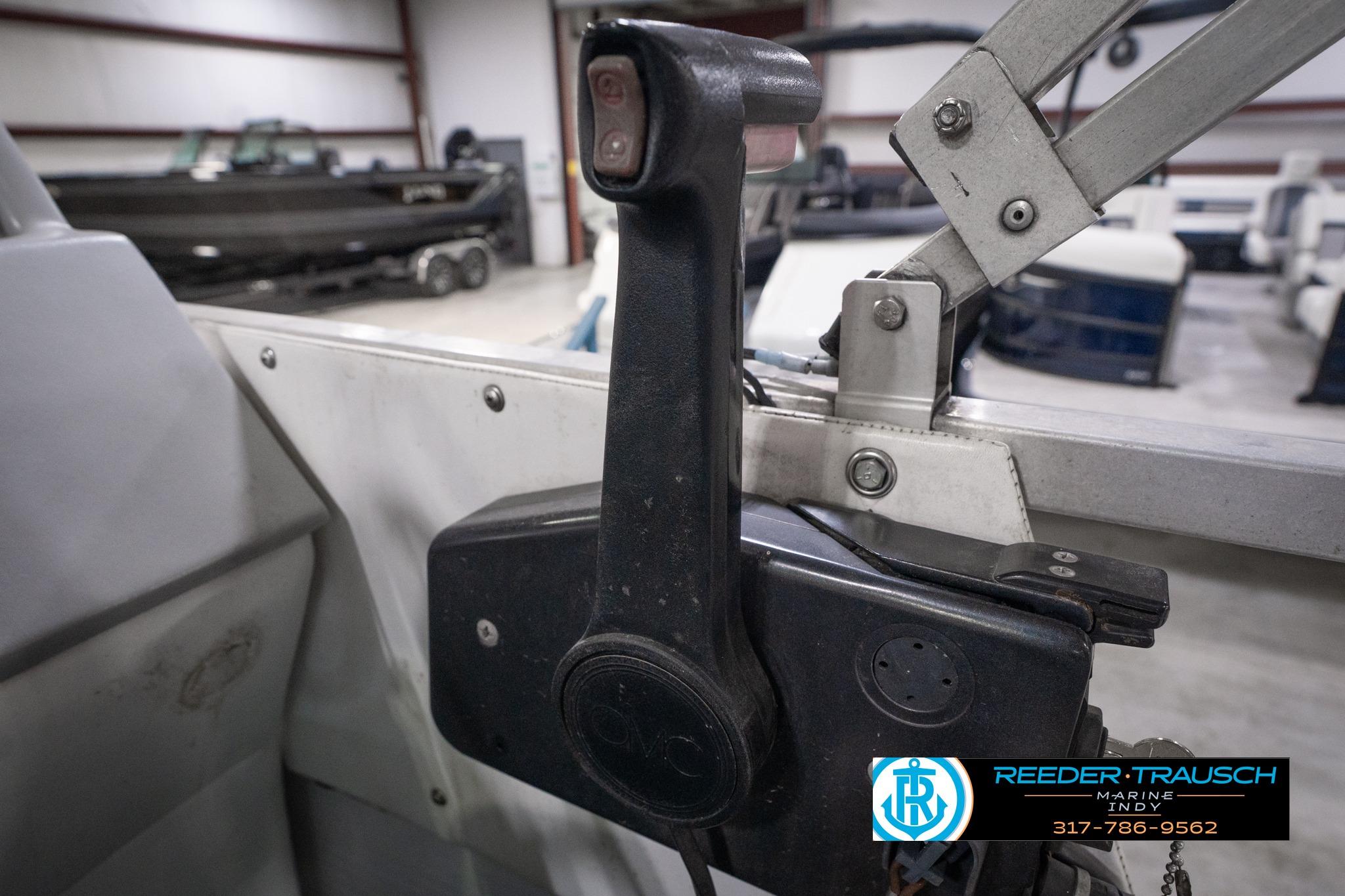 Close-up of a 1992 Godfrey Sweetwater boat throttle control in a showroom.
