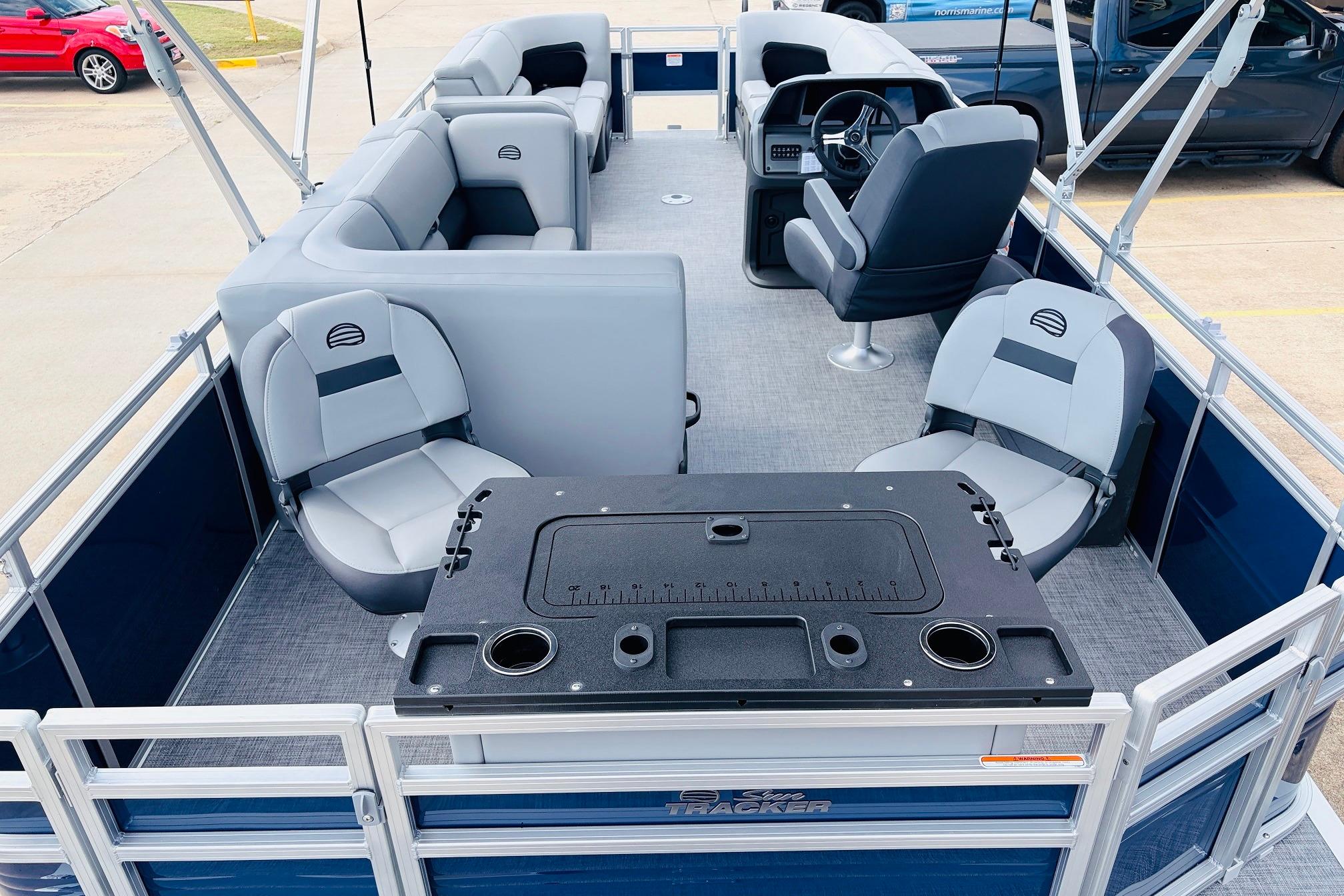 2026 Sun Tracker SportFish 22 DLX pontoon boat interior with seating and helm.
