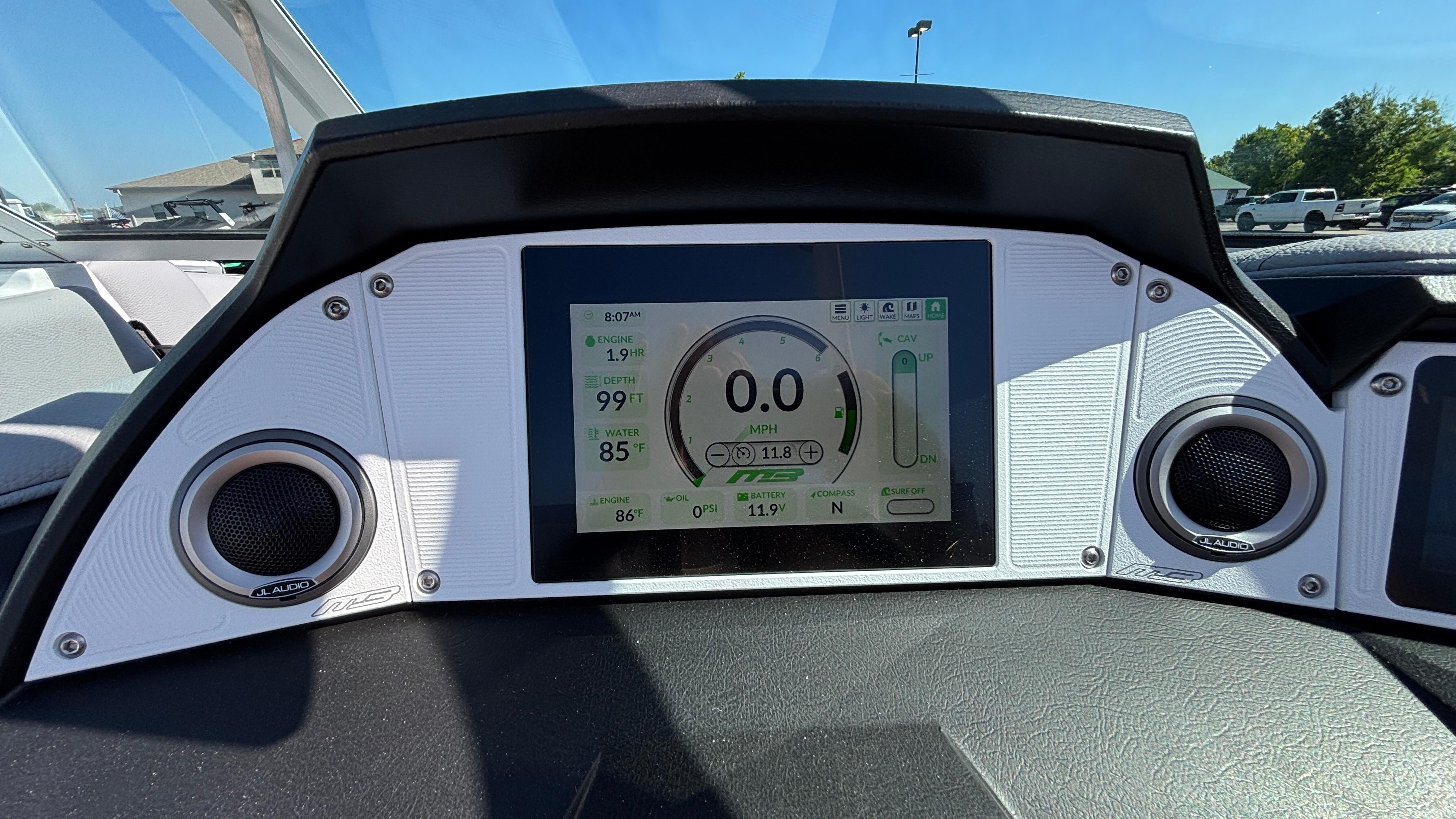 Dashboard of 2025 MB B52 25 Alpha boat with digital display and speakers.