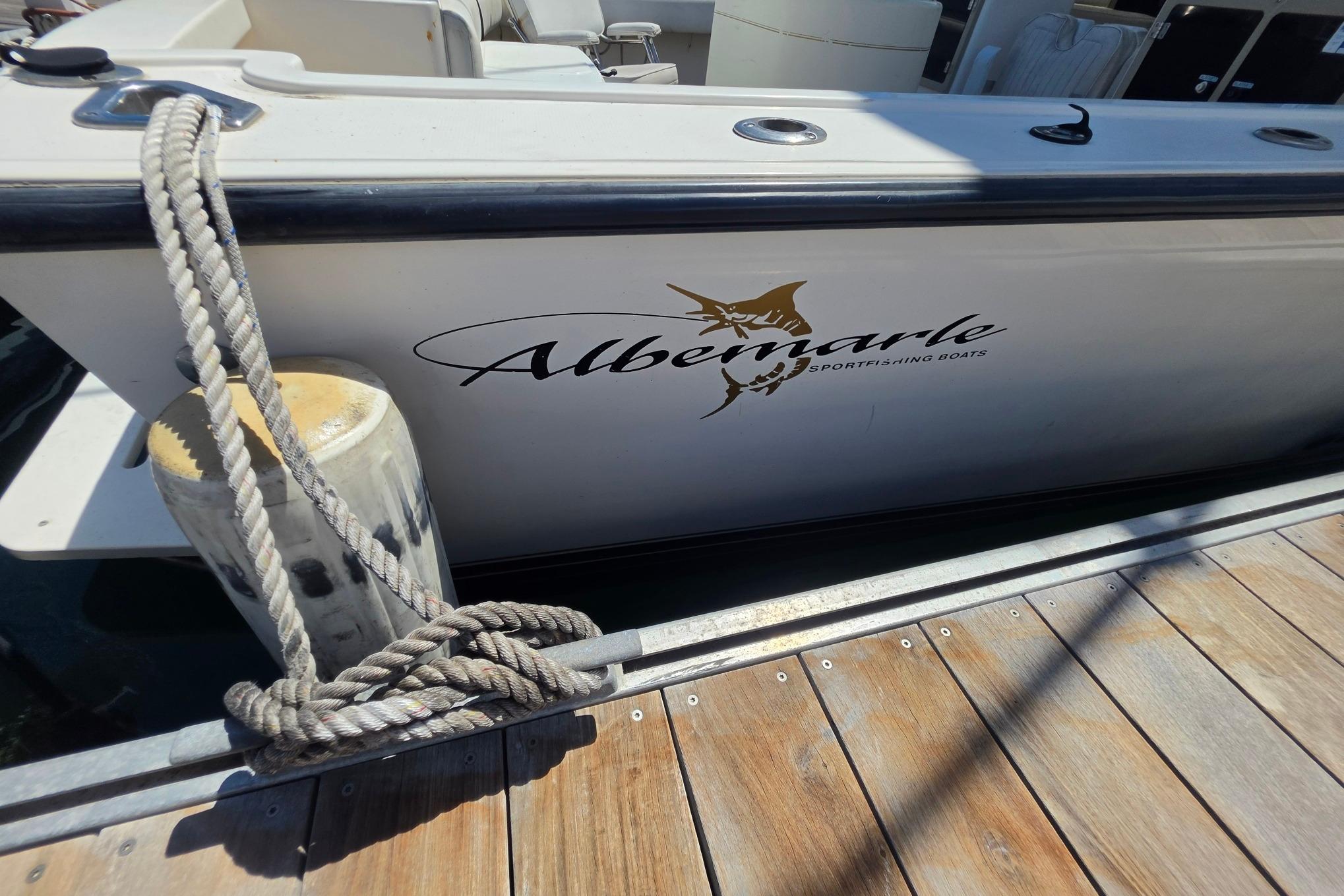 1999 Albemarle 305 Express Fisherman boat docked with rope tied to cleat.
