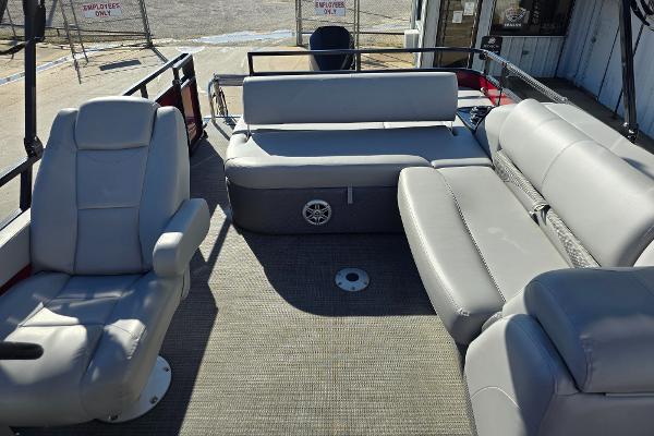 2023 Regency 250 DL3 pontoon boat interior with gray seating and spacious layout.