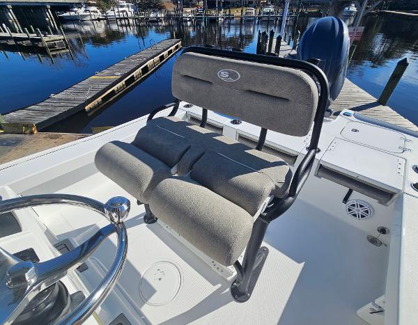 2026 Sea Hunt BX 22 BR boat interior with cushioned seating and steering wheel, dockside view.