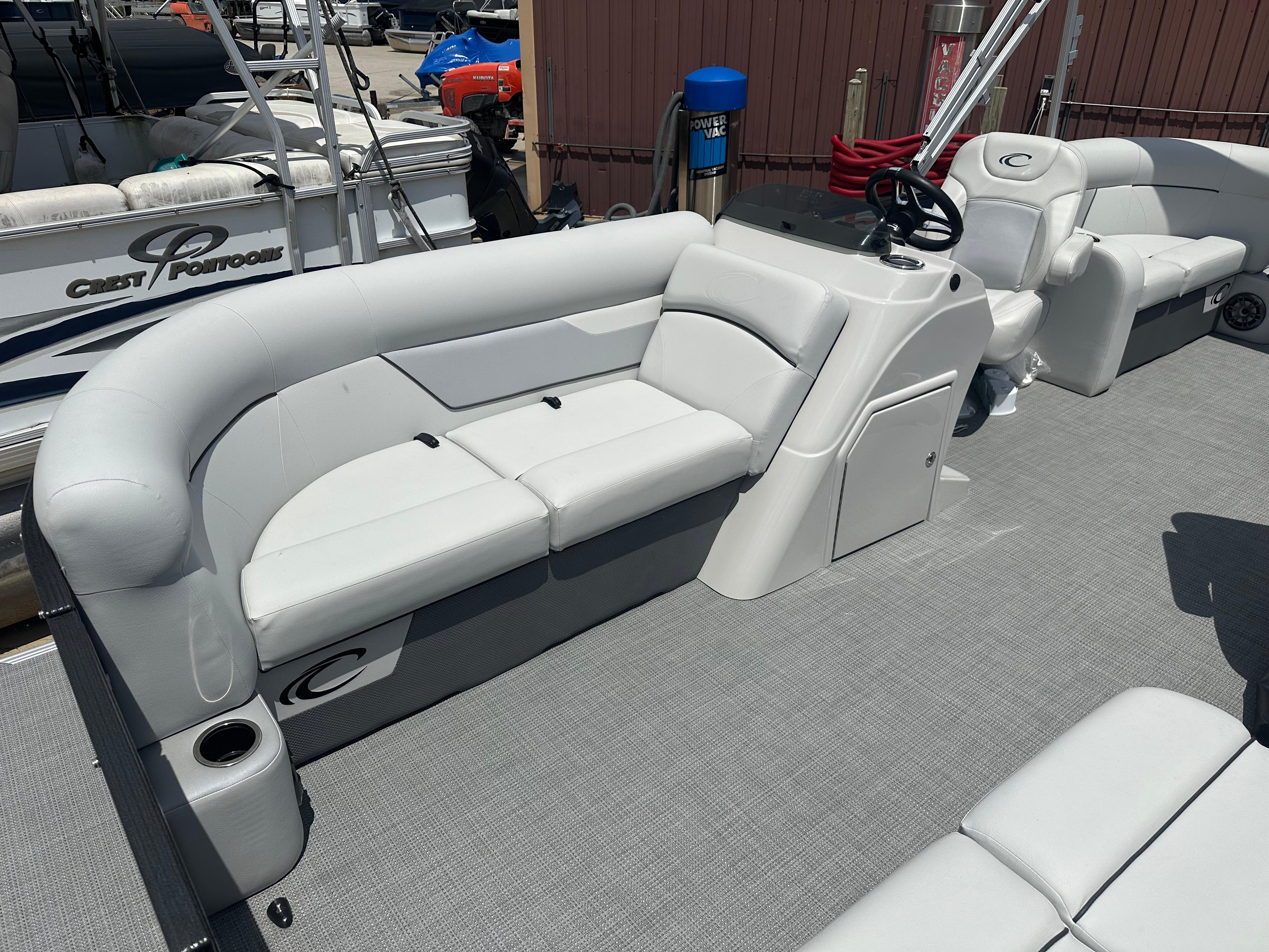 2022 Crest Classic DLX 200 SLC pontoon boat interior with plush seating and helm station.