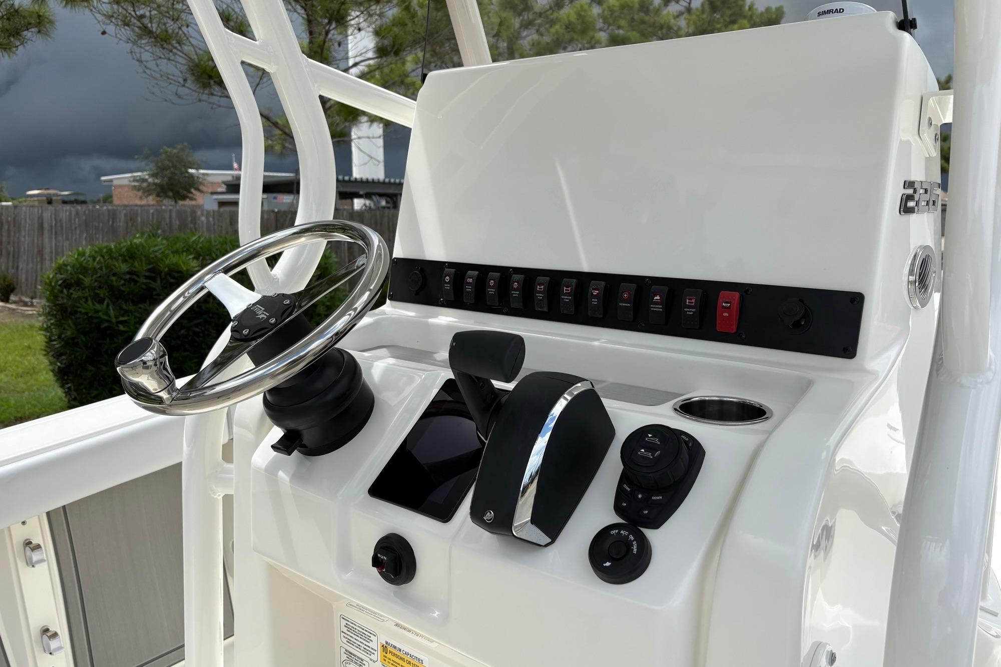 2026 Mako 226 Center Console boat dashboard with steering wheel and controls.