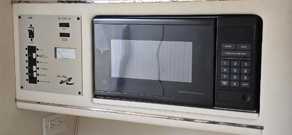 1999 Sea Ray 280 SS interior with microwave and control panel.