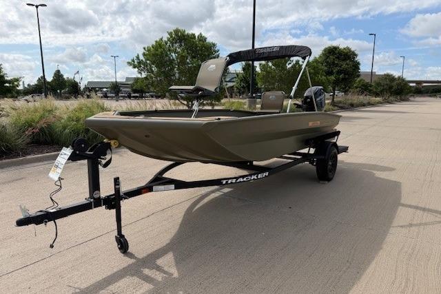 2026 Tracker Grizzly 1756 T Marsh boat on trailer, parked outdoors under cloudy sky.