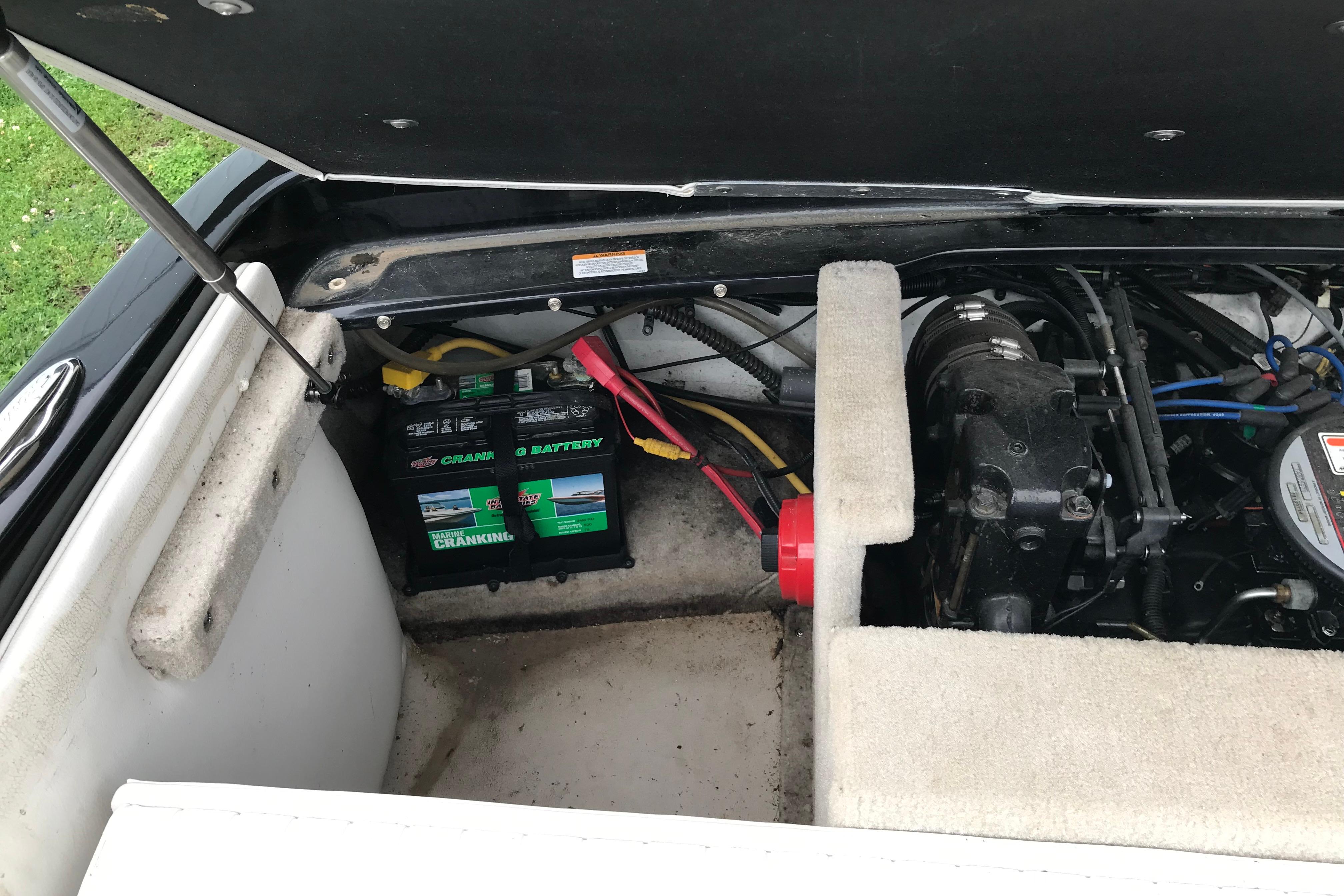 2015 Crownline 18 SS boat engine compartment with battery and wiring.