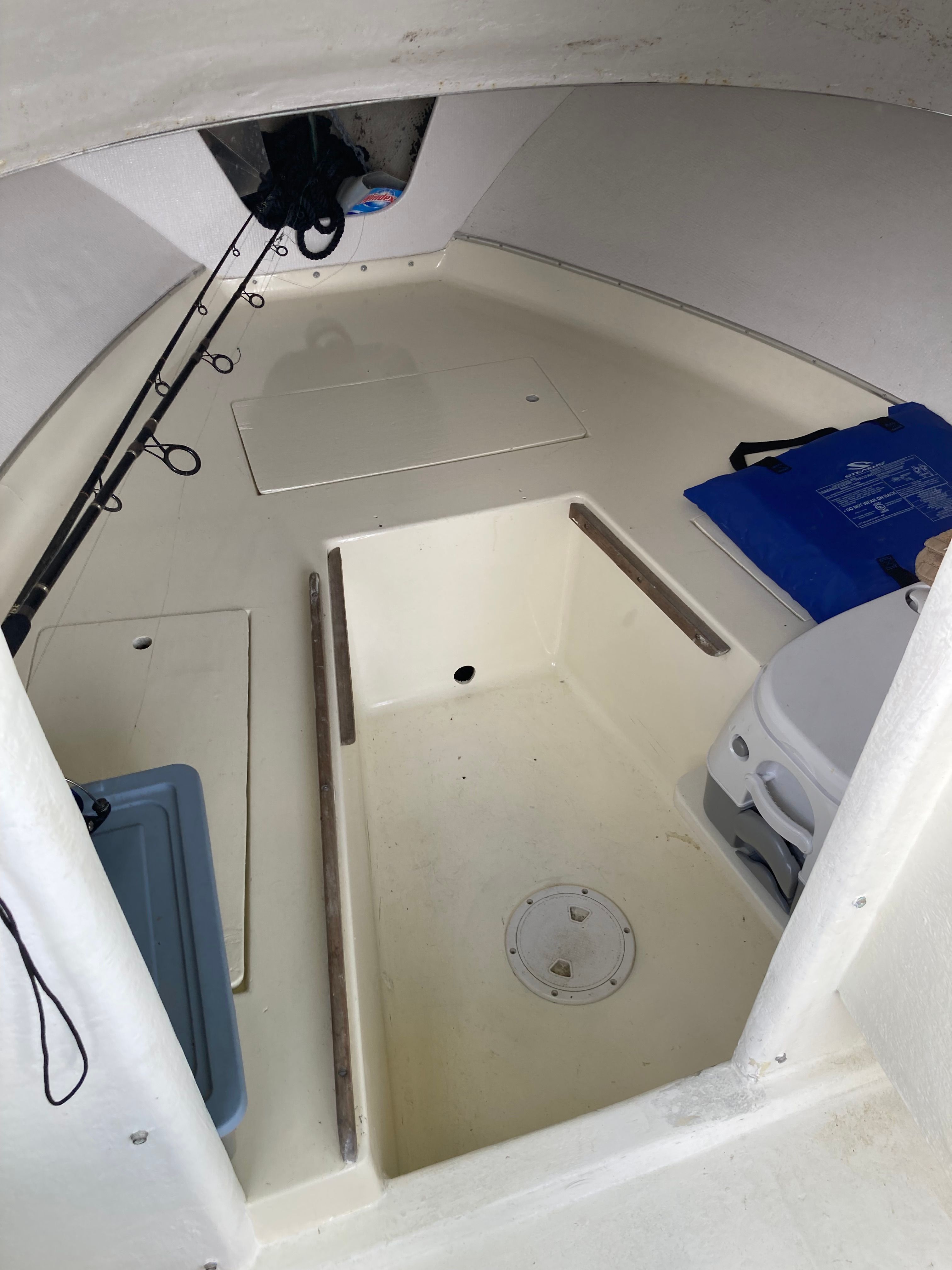 Interior of a 1969 Bertram Bahia Mar with storage and fishing rods.