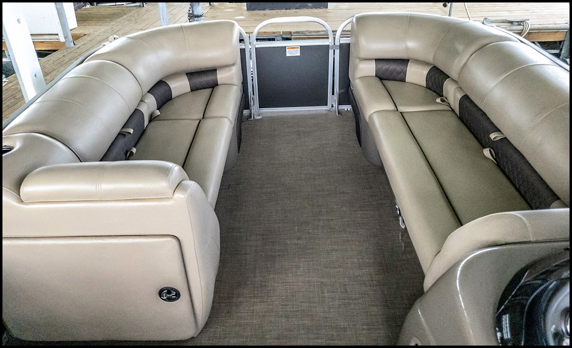 Interior of a Sun Tracker Party Barge 20 DLX with beige seating.