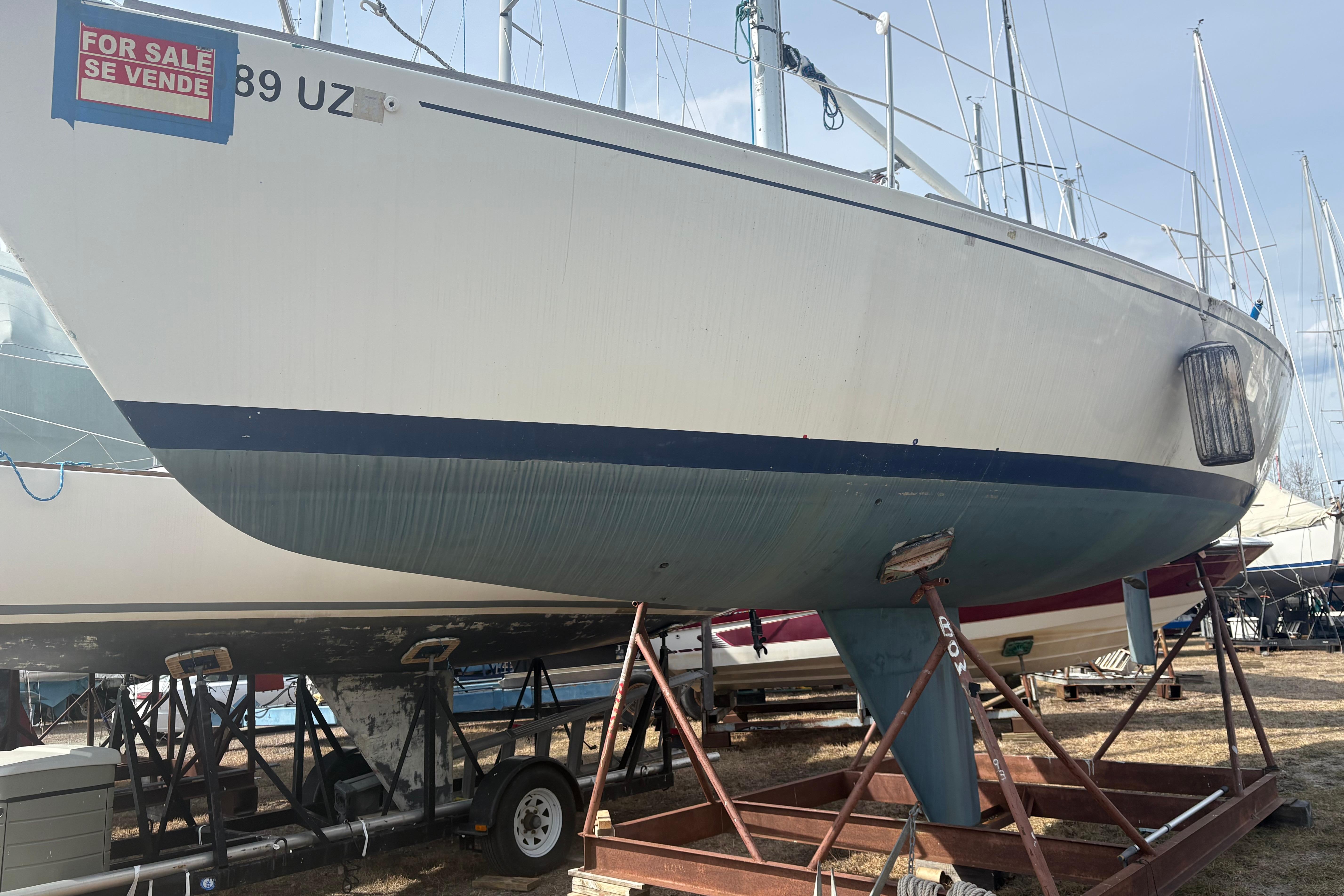 1976 J Boats J/29 sailboat on stands, for sale, with visible keel and hull.