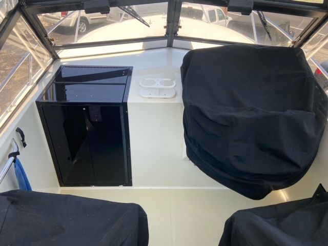 Interior of a 2002 Carolina Classic 25 boat with covers.