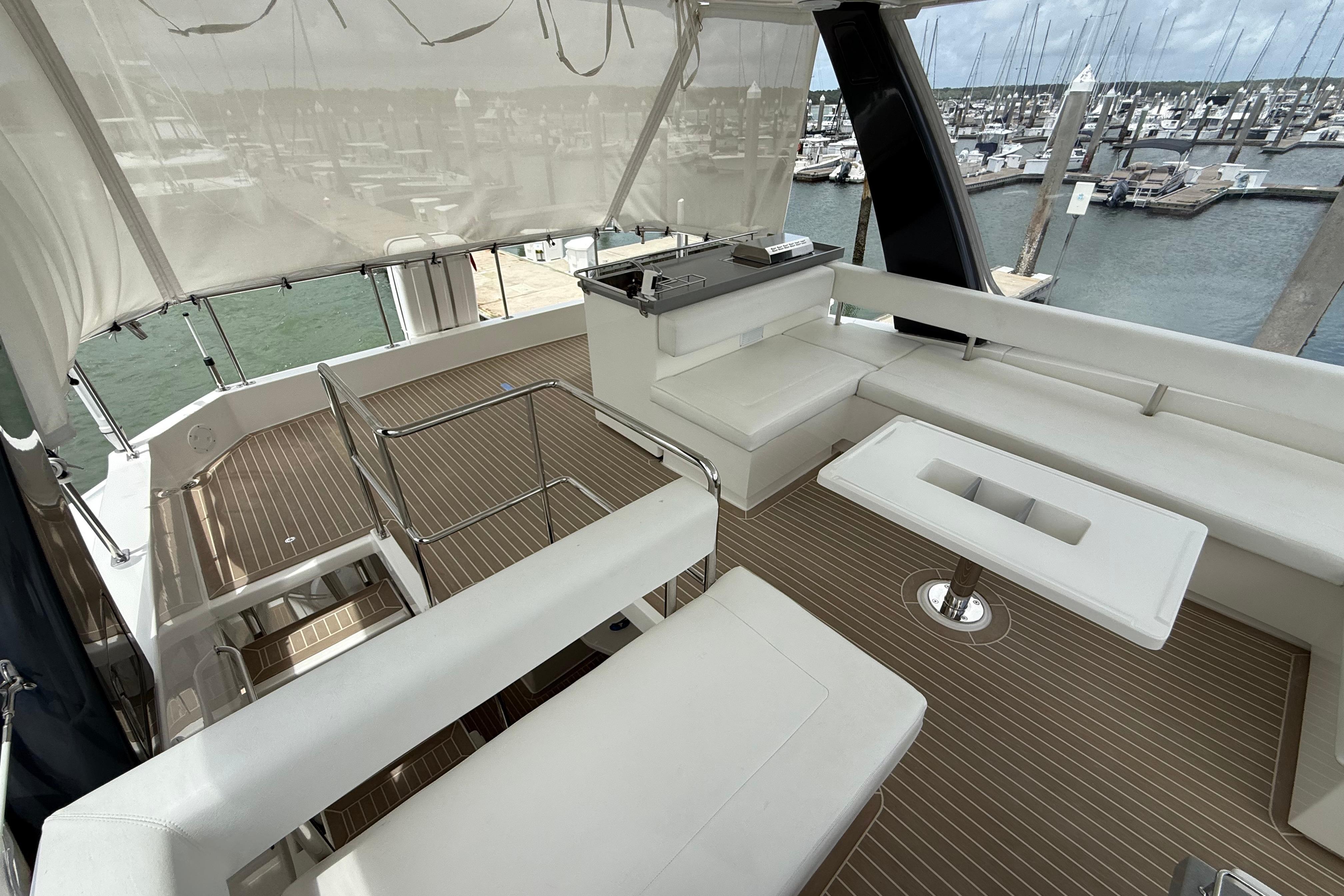 Luxurious 2021 Leopard 43 Powercat yacht interior with spacious seating and marina view.
