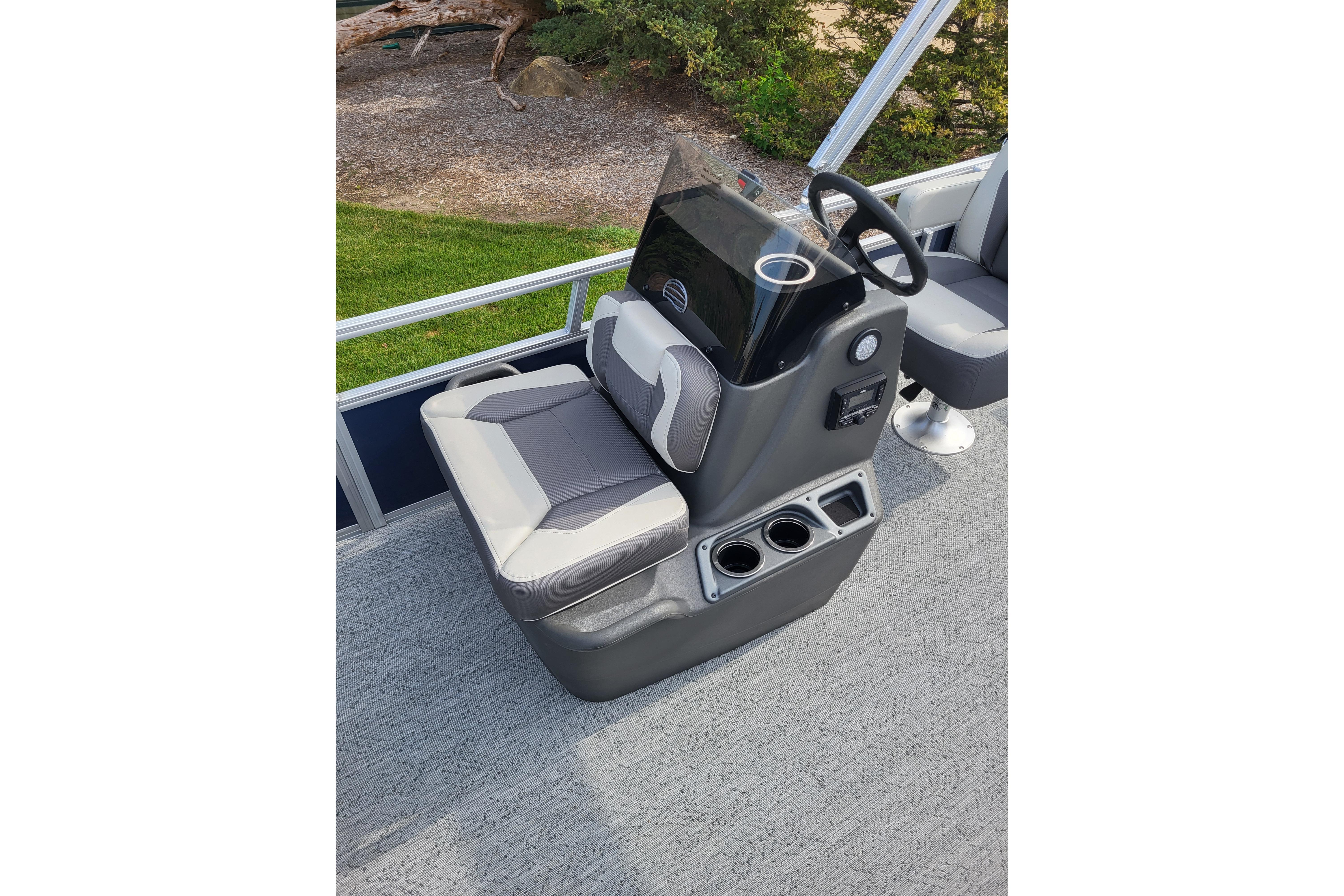 2026 Sun Tracker Bass Buggy 16 XL Select boat console with seating and steering wheel.