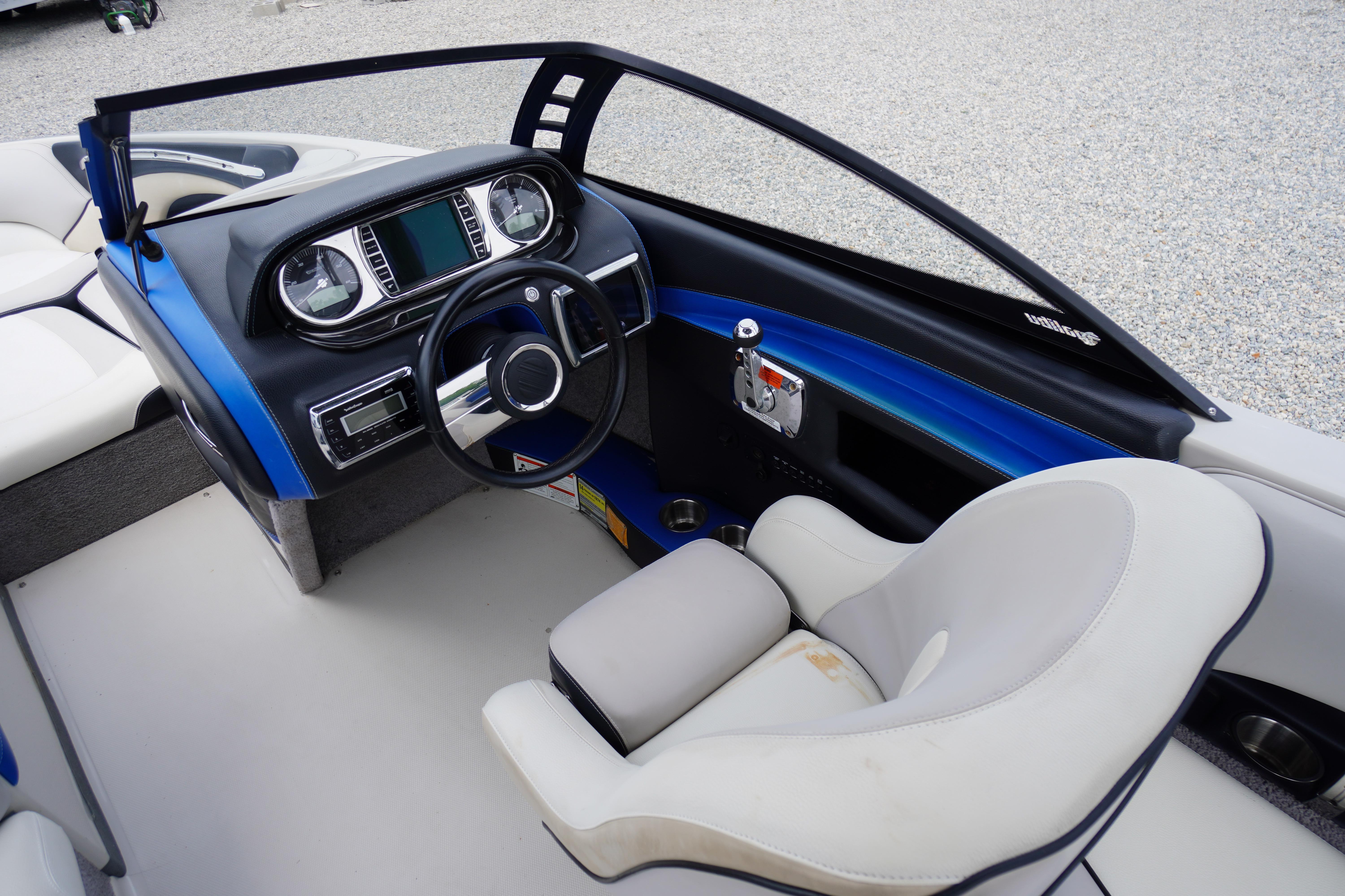 Interior of 2011 Malibu Wakesetter 21 VLX boat with modern dashboard and steering wheel.