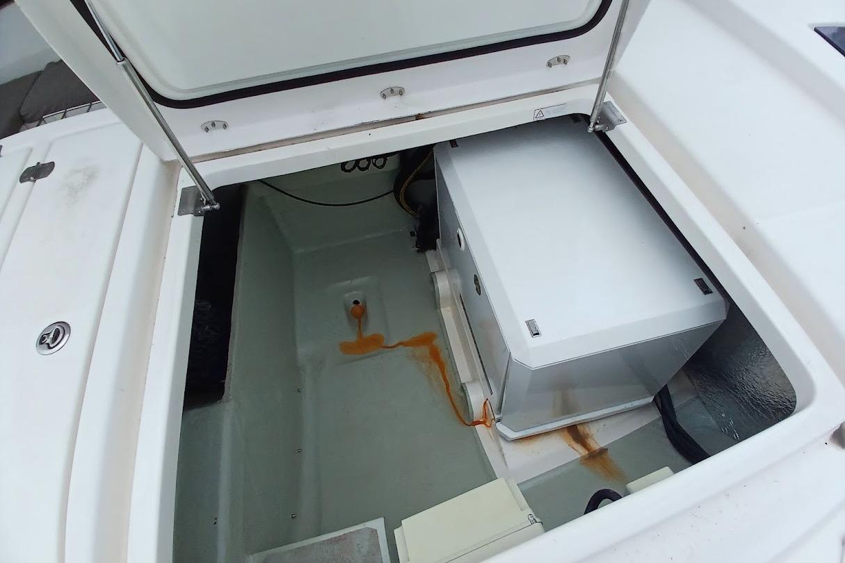 Open storage compartment on a 2019 Leopard 45 yacht, showing equipment and rust stains.