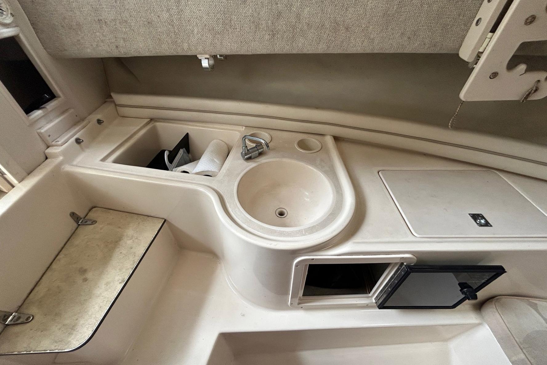 2004 Grady-White Gulfstream 232 boat interior with sink and storage compartments.