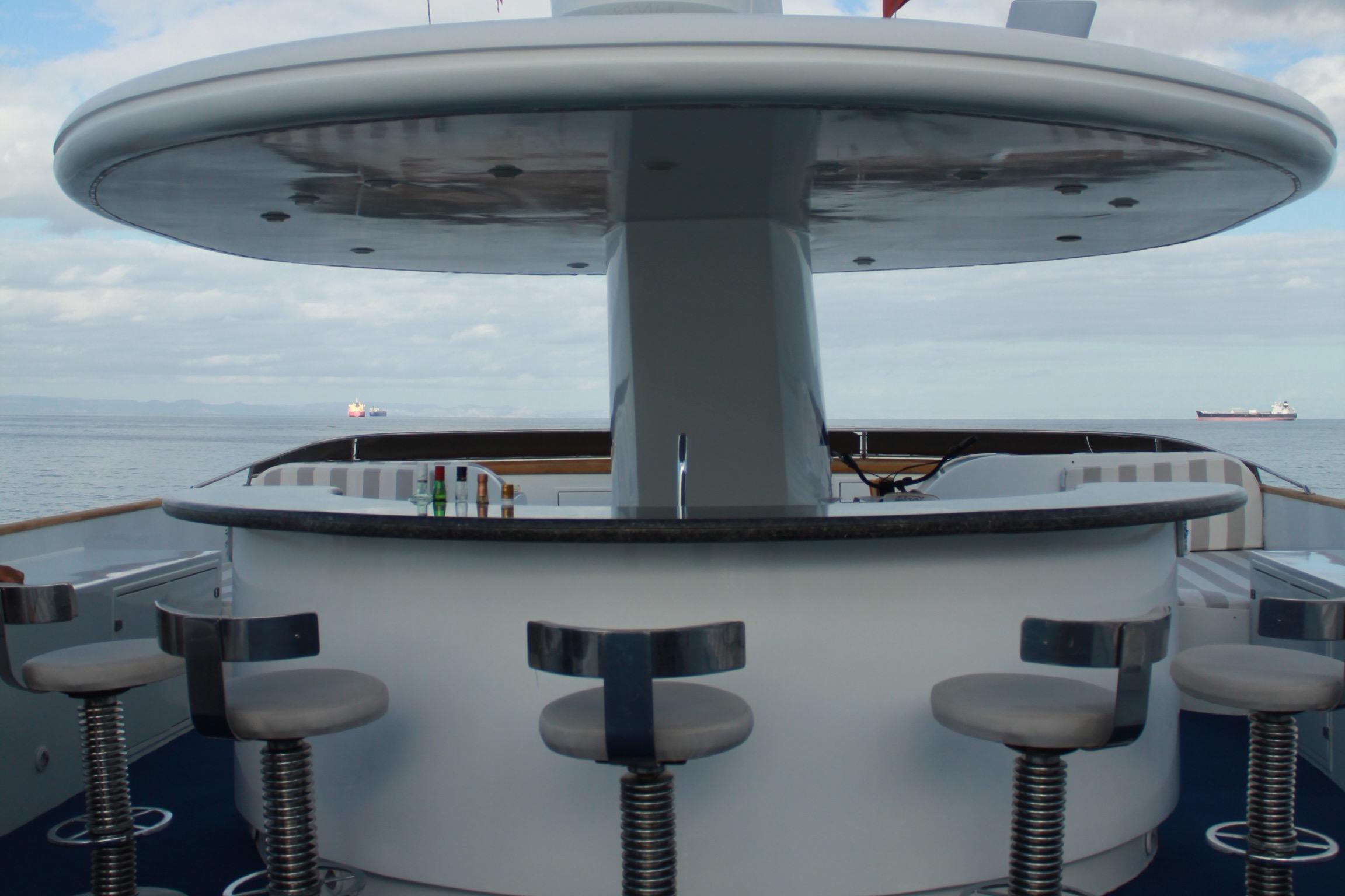 Outdoor bar area on 1984 DeFever 120 yacht with ocean view.