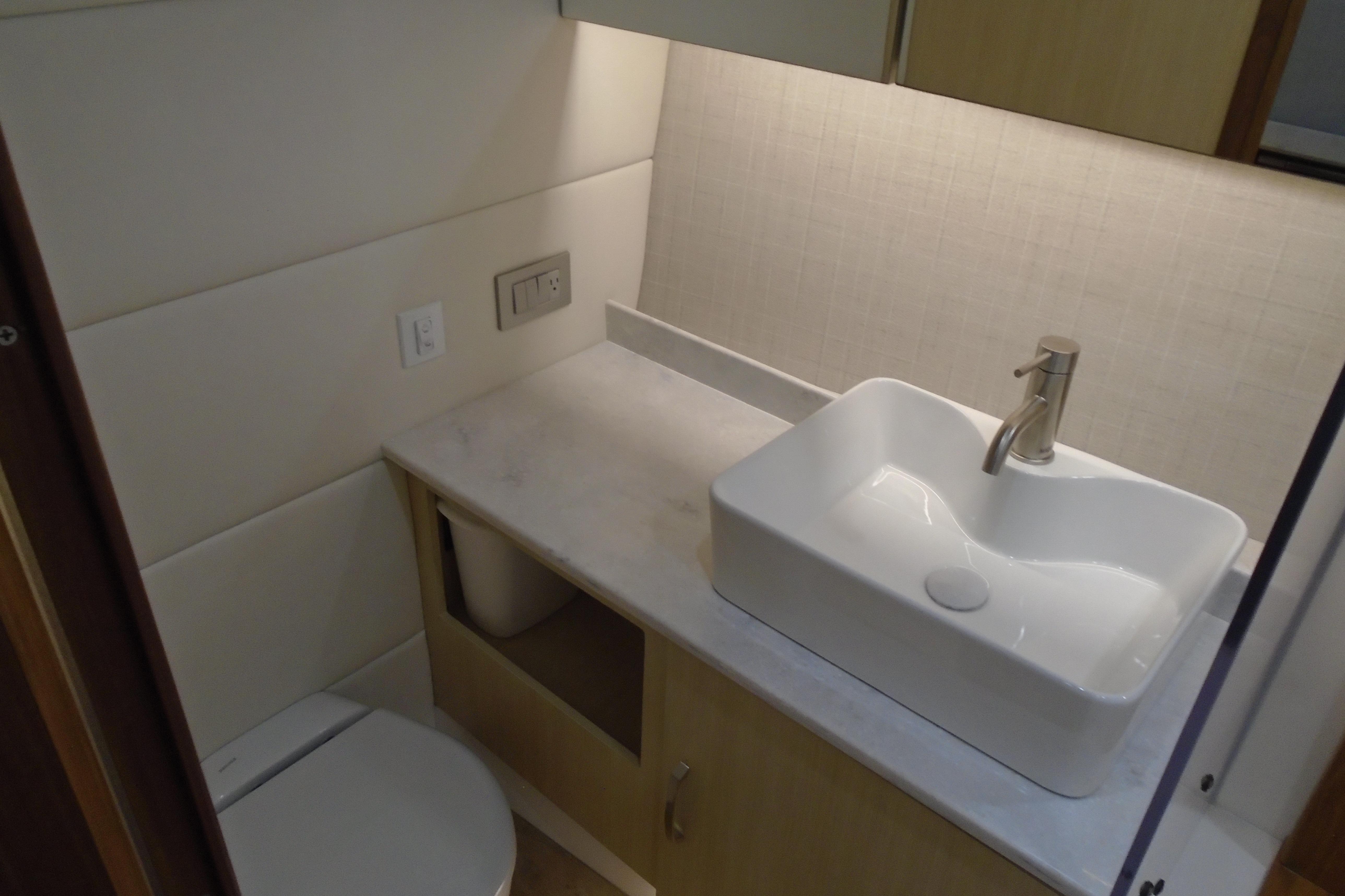 Modern bathroom interior of 2026 Regal 38 SAV yacht with sleek sink and countertop.