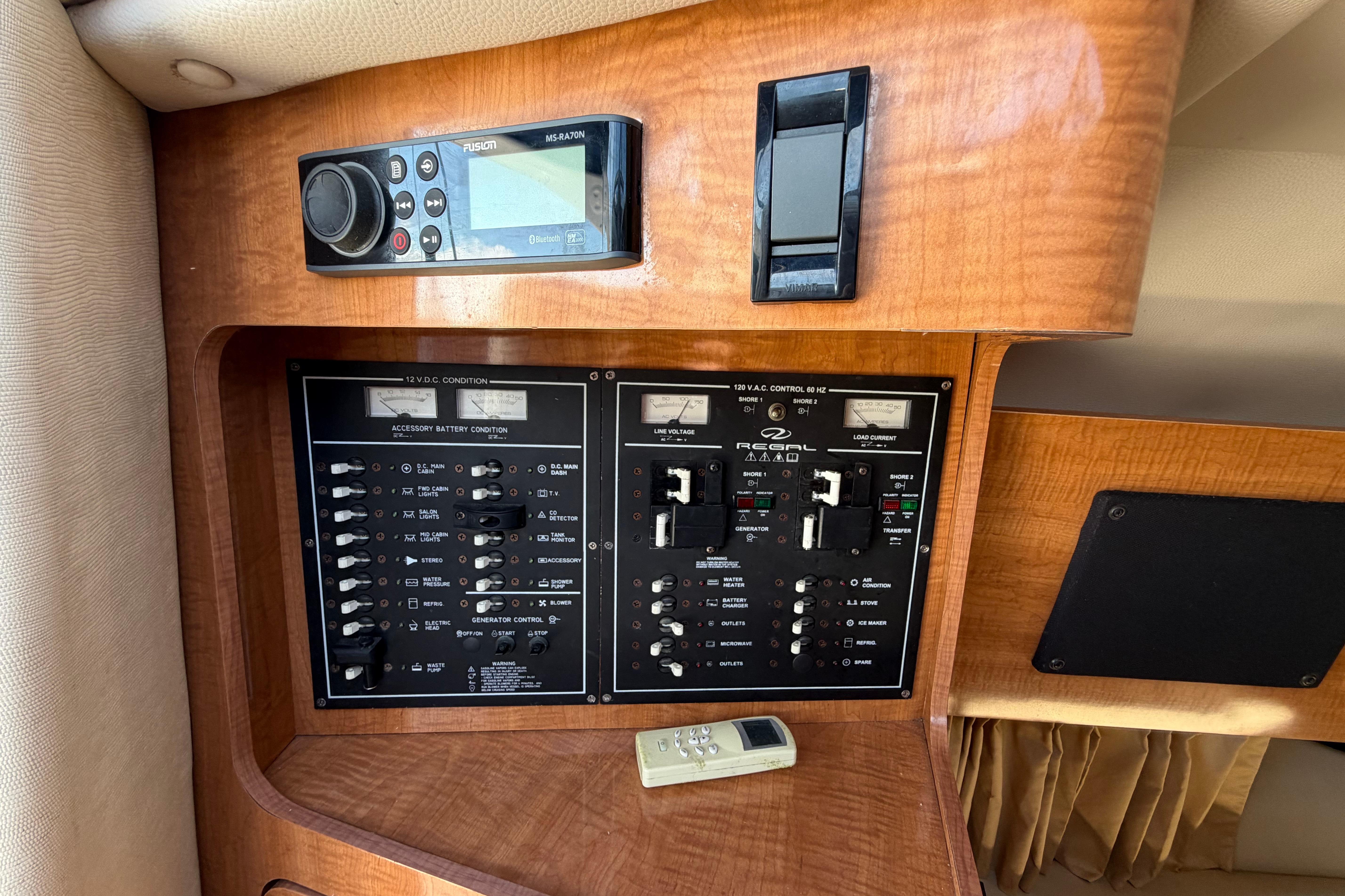 Control panel of a 2003 Regal Commodore 3260 boat with audio system and switches.