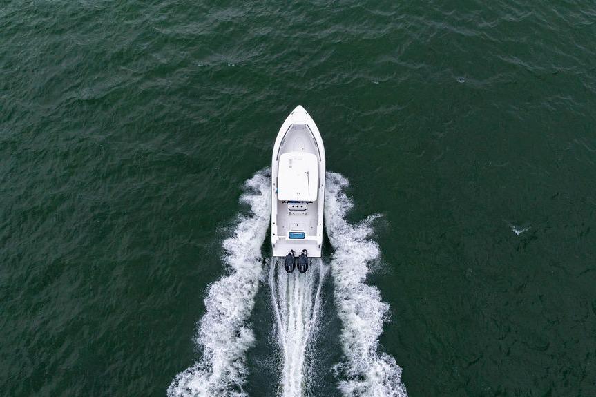 Aerial view of 2027 Reef Runner 280 boat cruising on open water.